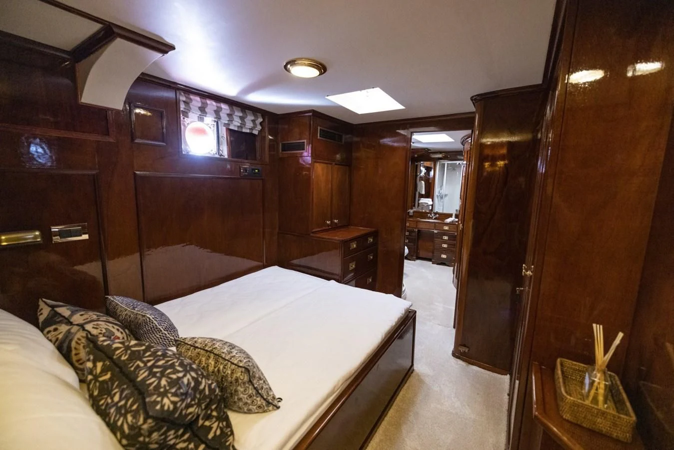 a room with a bed and a wood cabinet aboard FRANCESCO PETRARCA Yacht for Sale