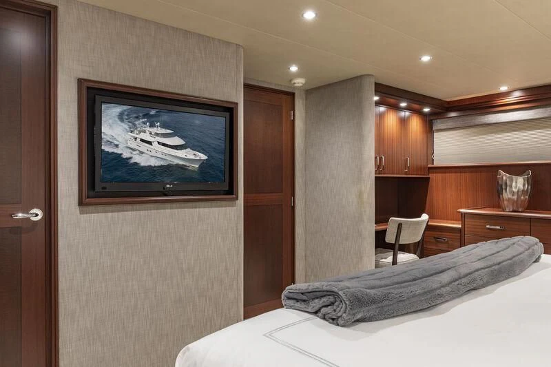 a bedroom with a television on the wall aboard CHERRY BOMB Yacht for Sale