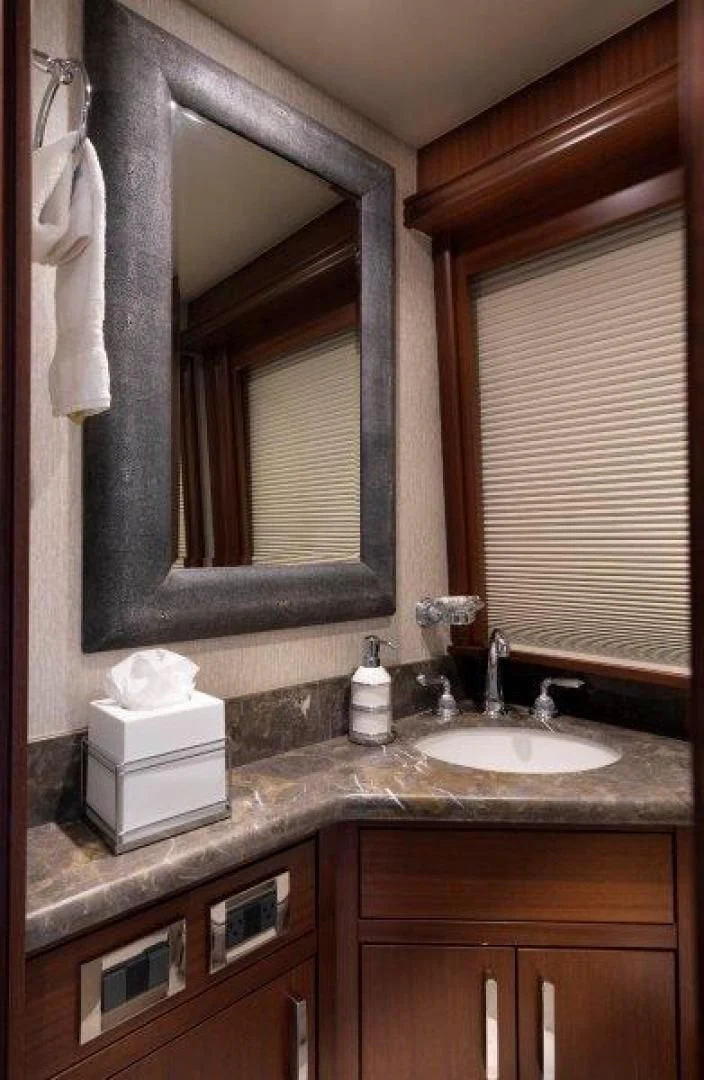 a bathroom with a mirror and a sink aboard CHERRY BOMB Yacht for Sale