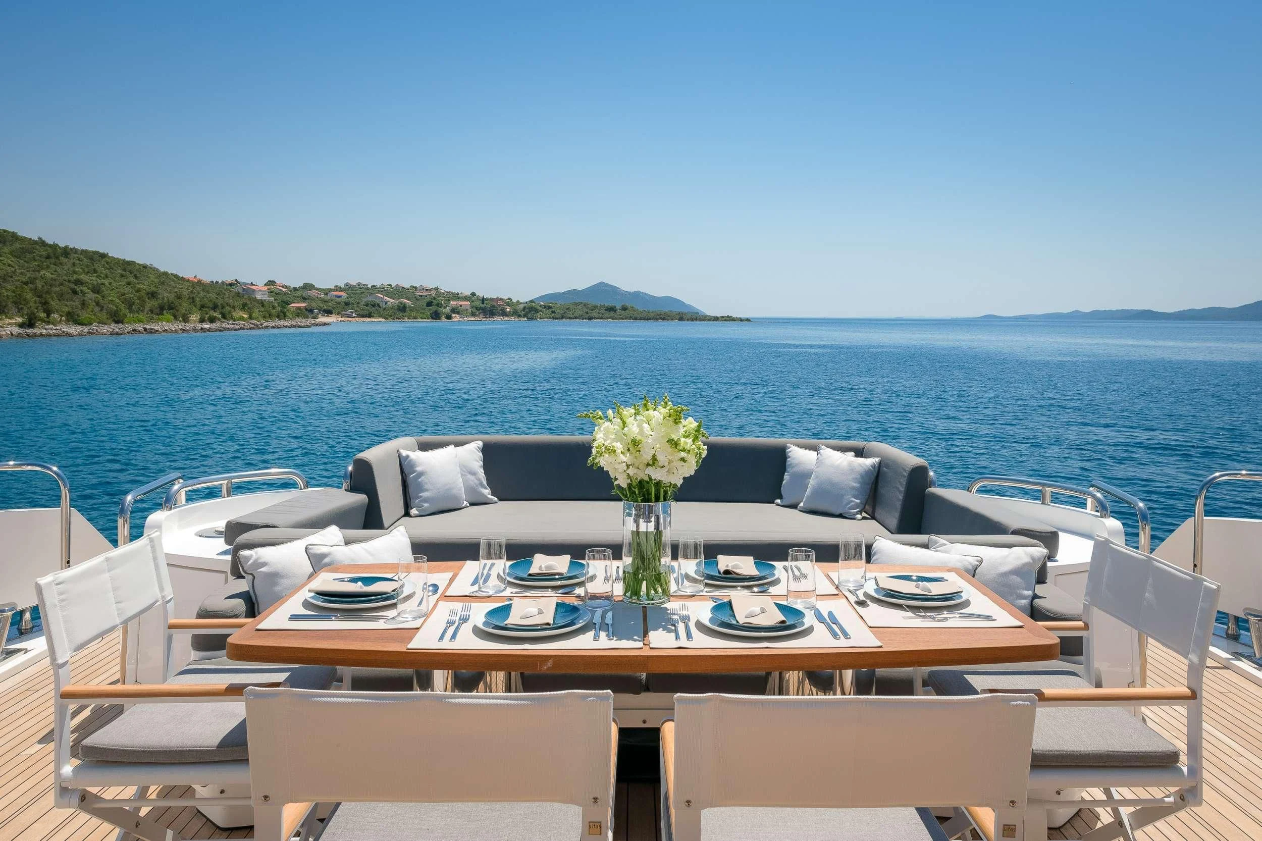 a table set for a dinner on a boat aboard QUANTUM Yacht for Sale