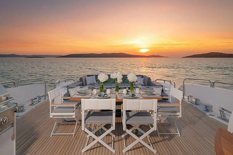 a table set for a dinner on a boat aboard QUANTUM Yacht for Sale