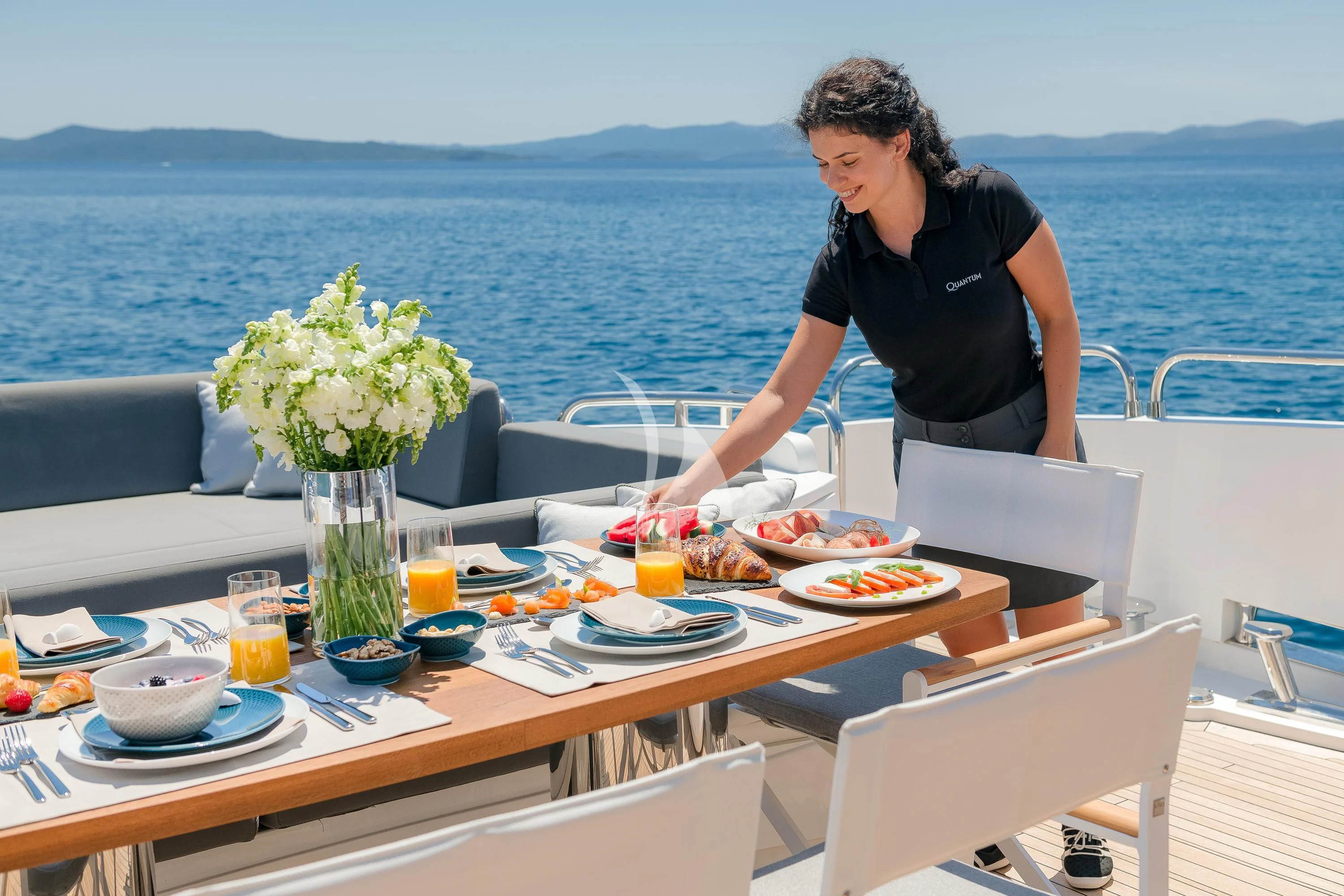a person preparing food on a boat aboard QUANTUM Yacht for Sale