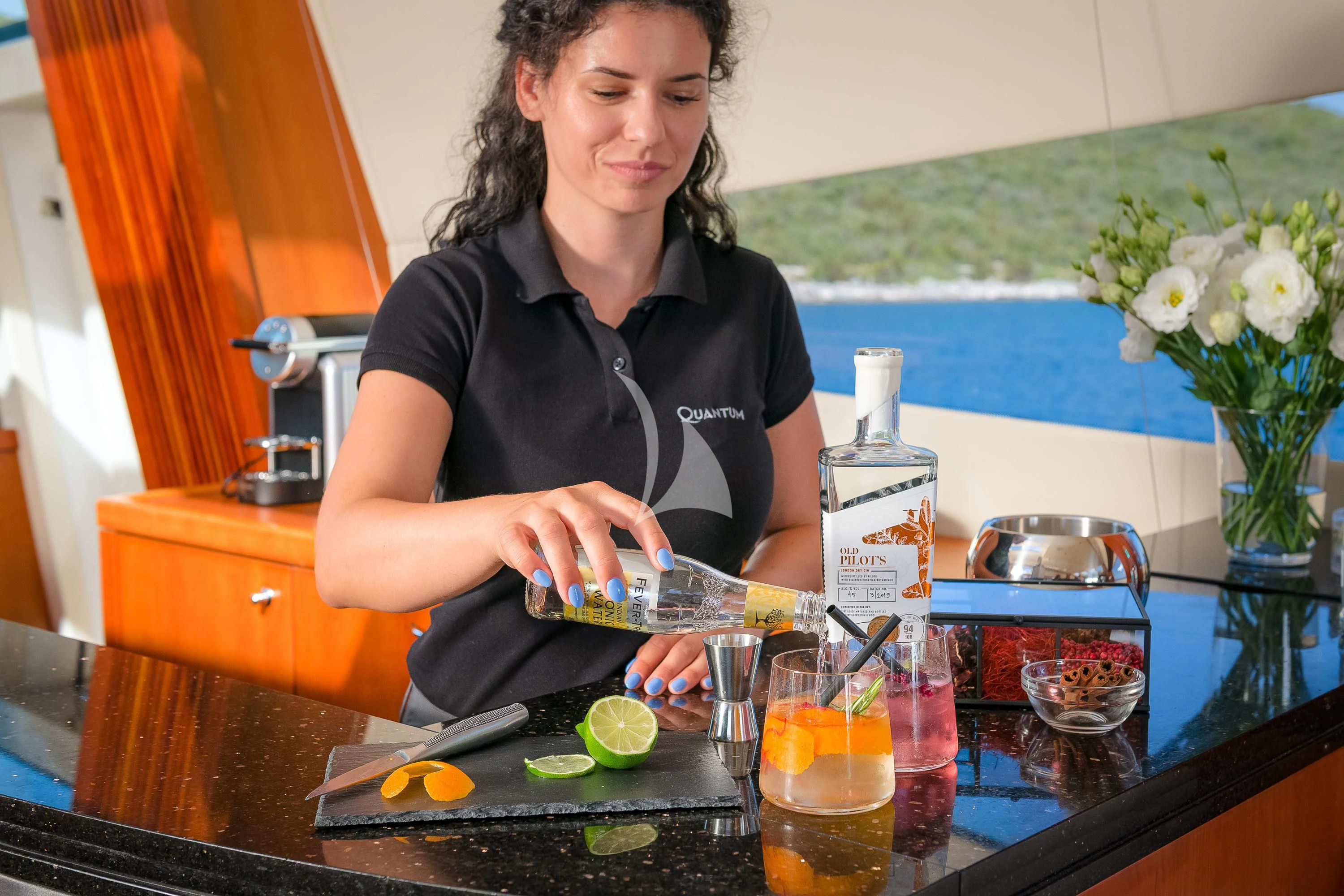 a woman sitting at a table aboard QUANTUM Yacht for Sale