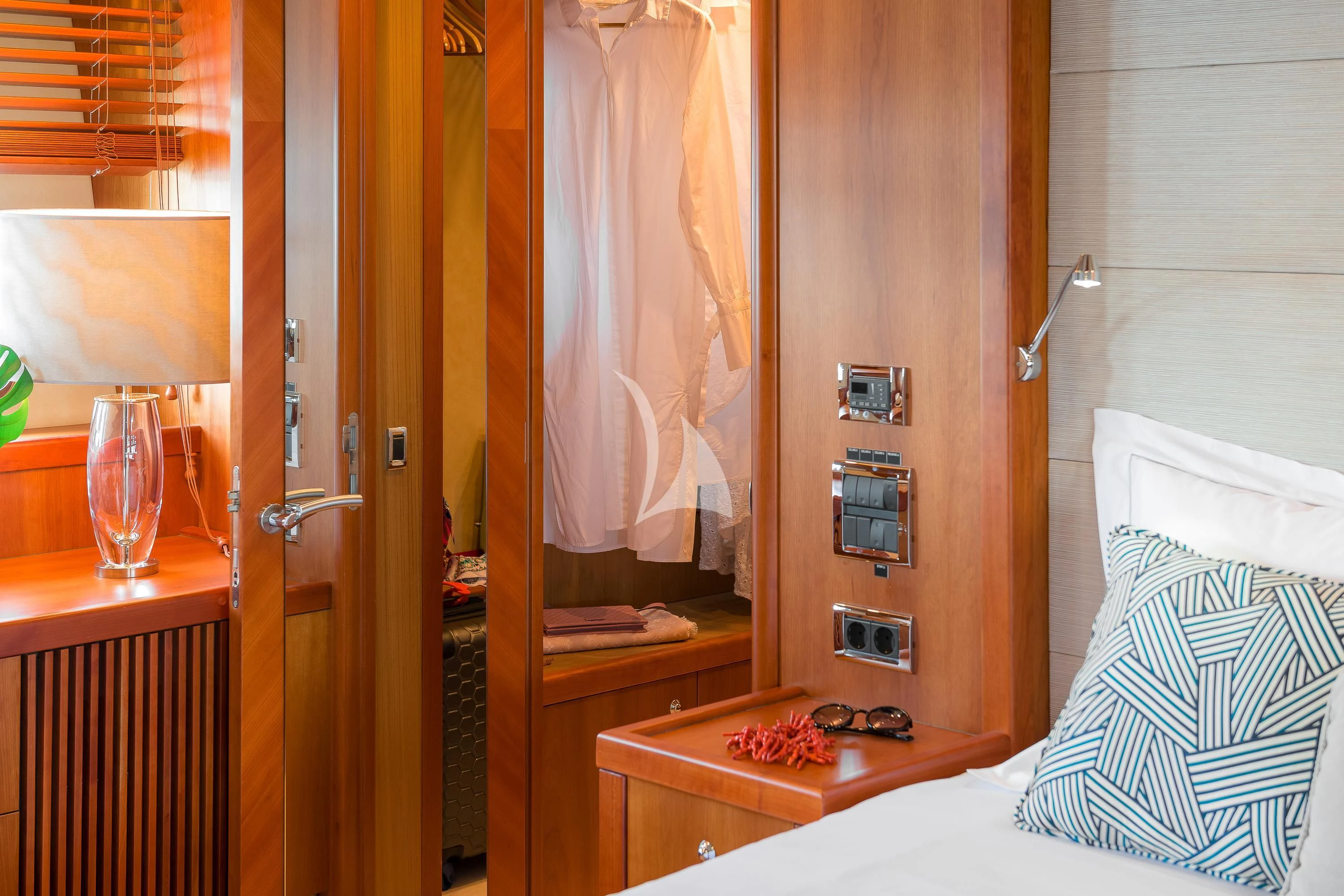 a room with a bed and a lamp aboard QUANTUM Yacht for Sale