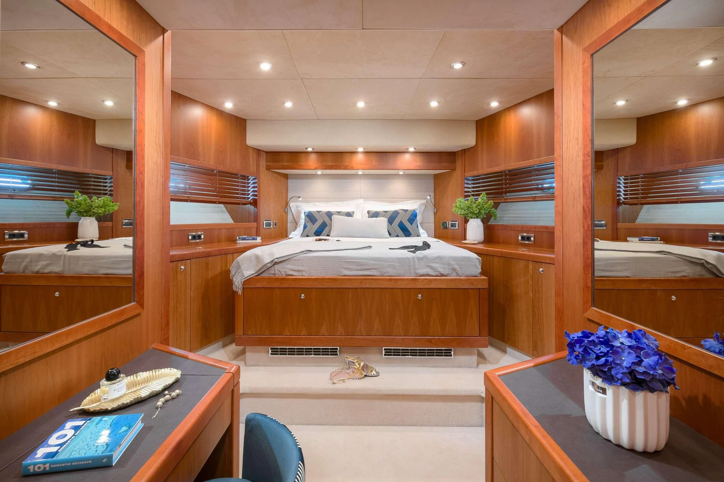 a room with a bed and desk aboard QUANTUM Yacht for Sale