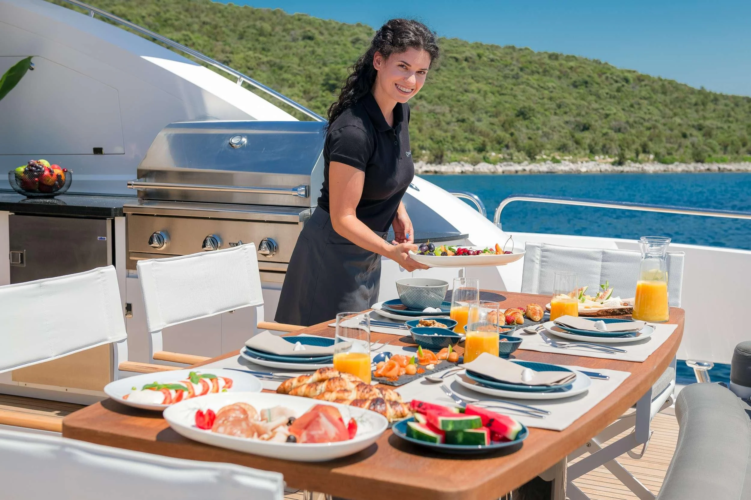 a person preparing food on a boat aboard QUANTUM Yacht for Sale