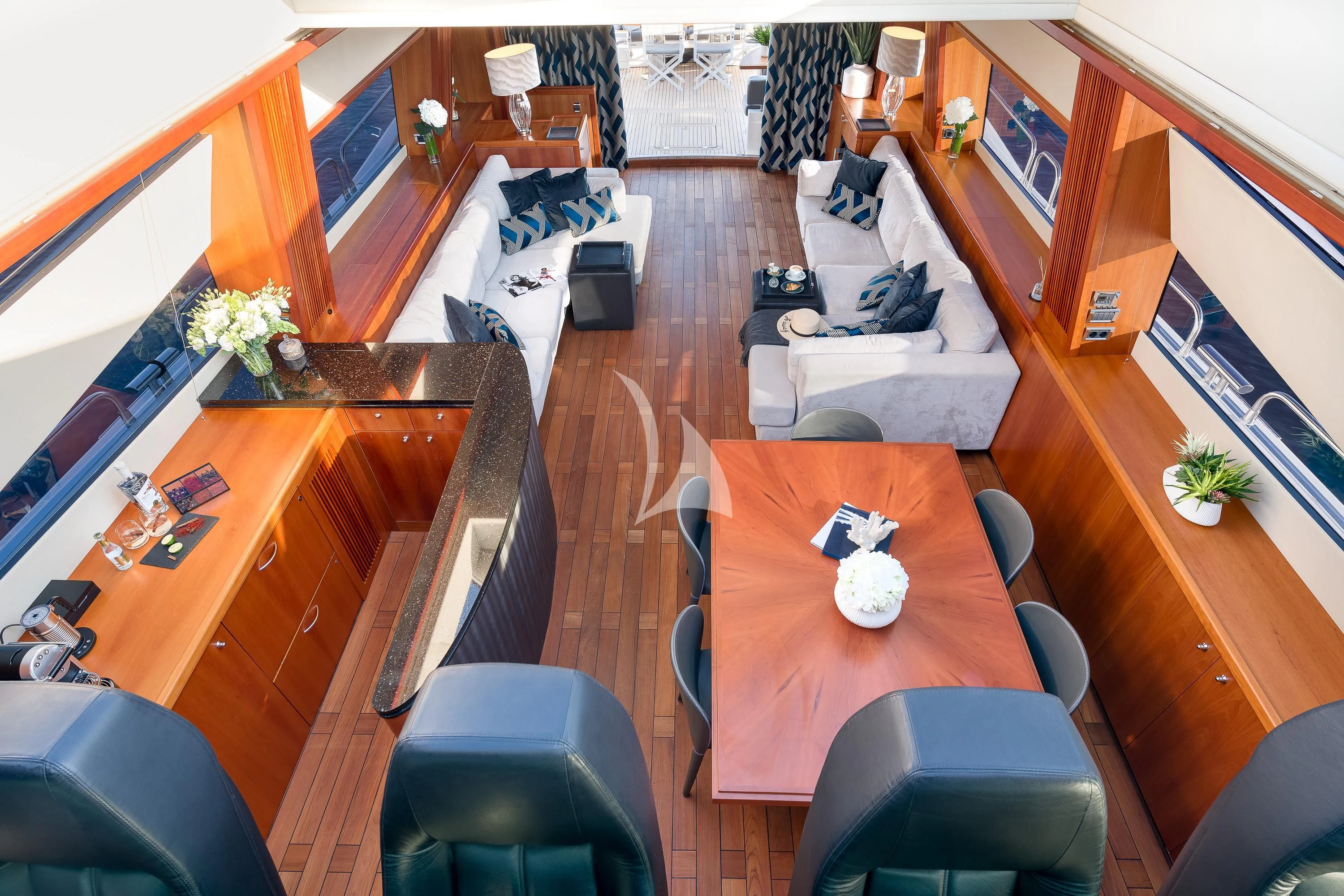 a living room with a table and couches aboard QUANTUM Yacht for Sale