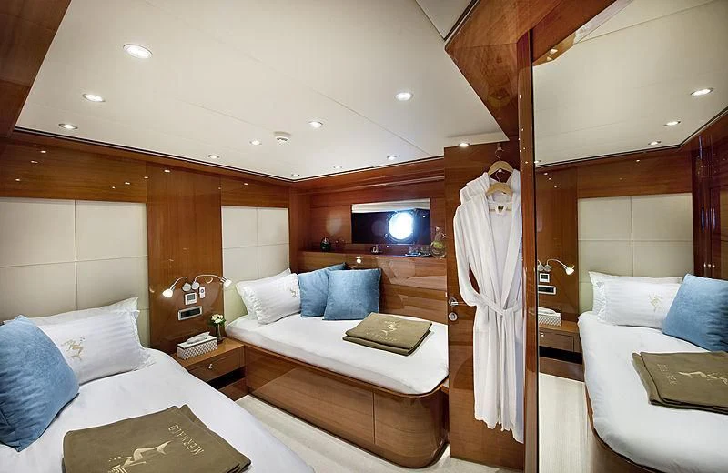 a room with a bed and a television aboard MERMAID Yacht for Sale