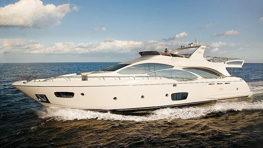 a white yacht on a beach aboard KOUKLES Yacht for Sale