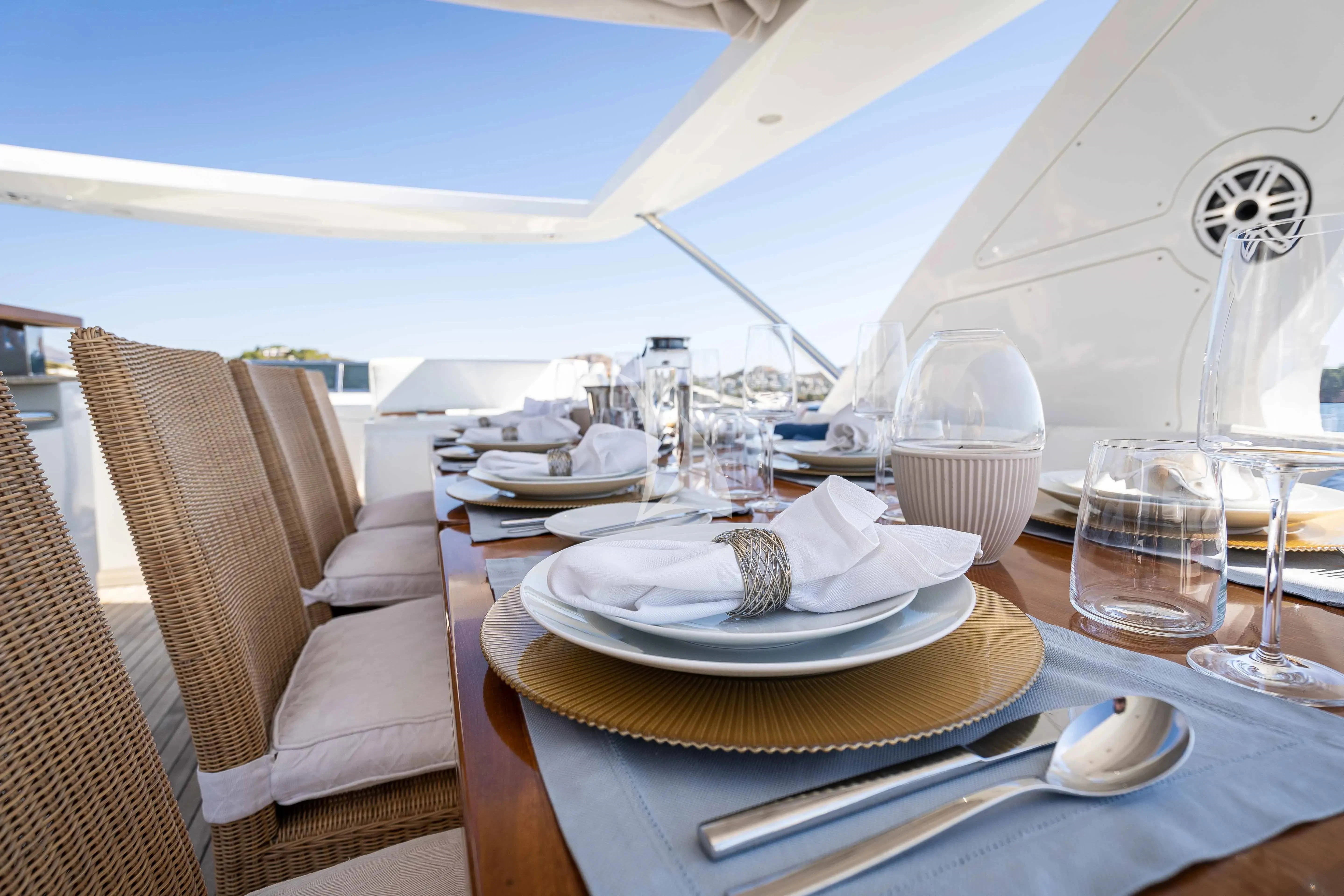 a table with plates and glasses on it aboard KOUKLES Yacht for Sale