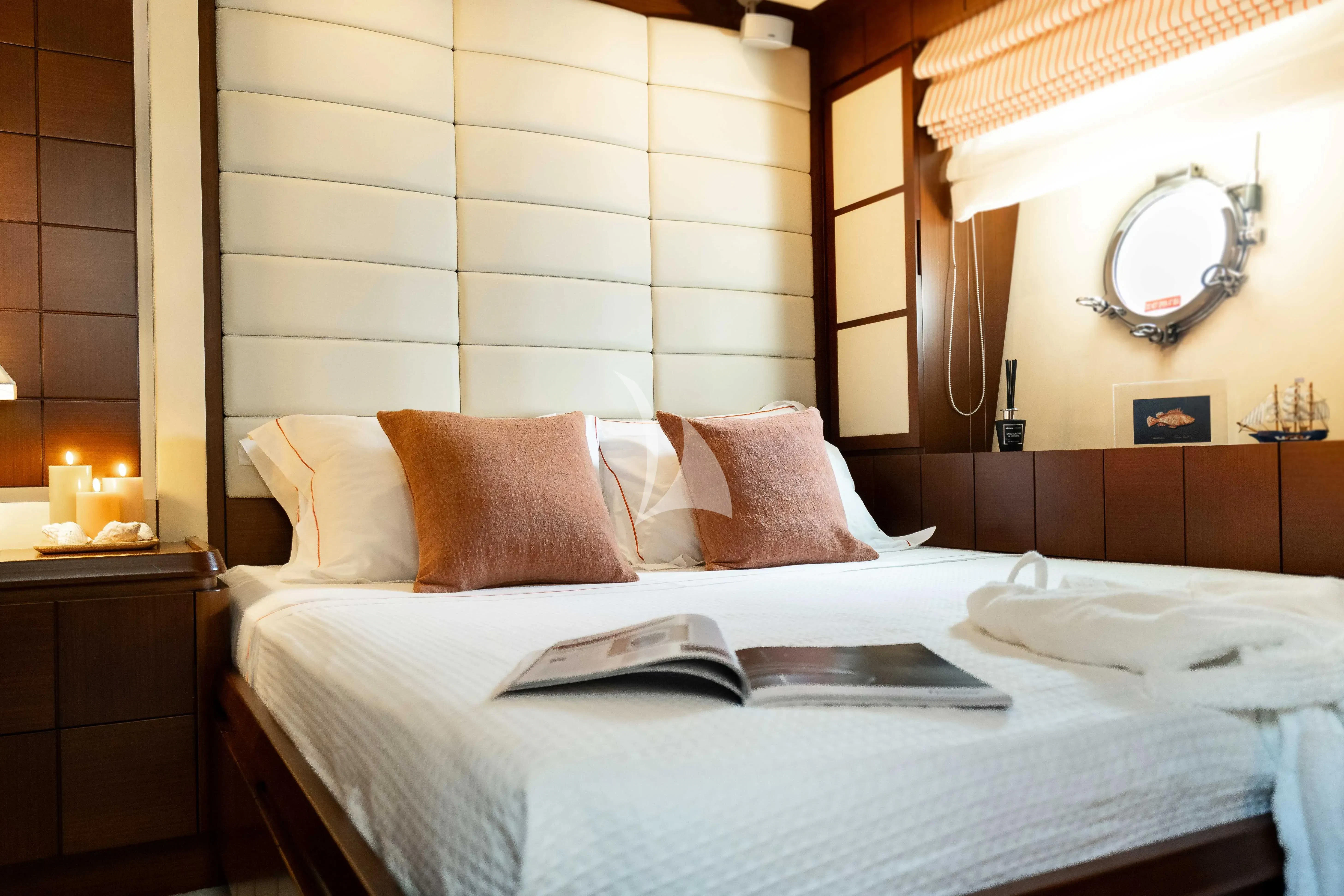 a bed with a white bed spread aboard KOUKLES Yacht for Sale