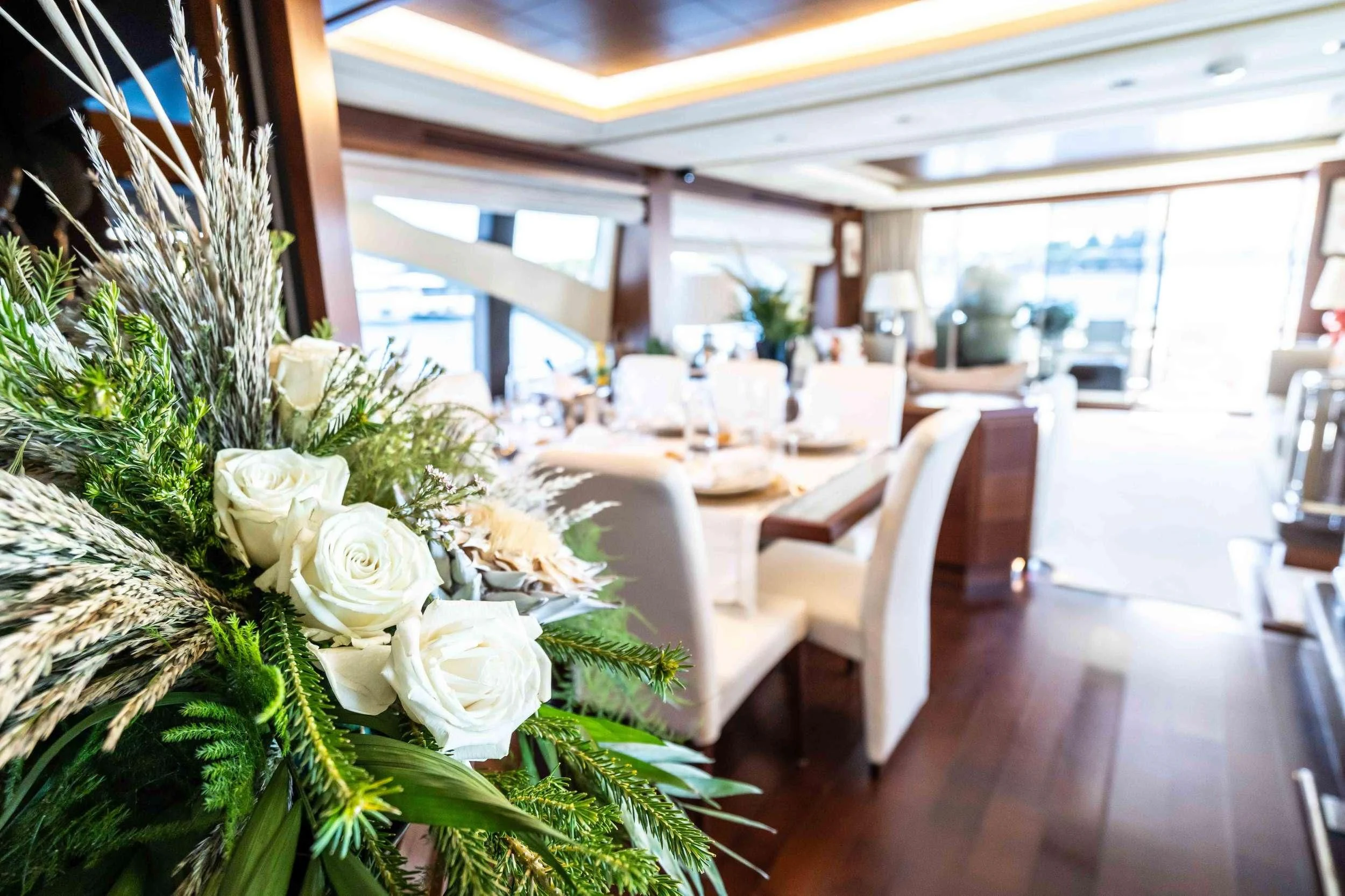 a room with tables and chairs aboard KOUKLES Yacht for Sale