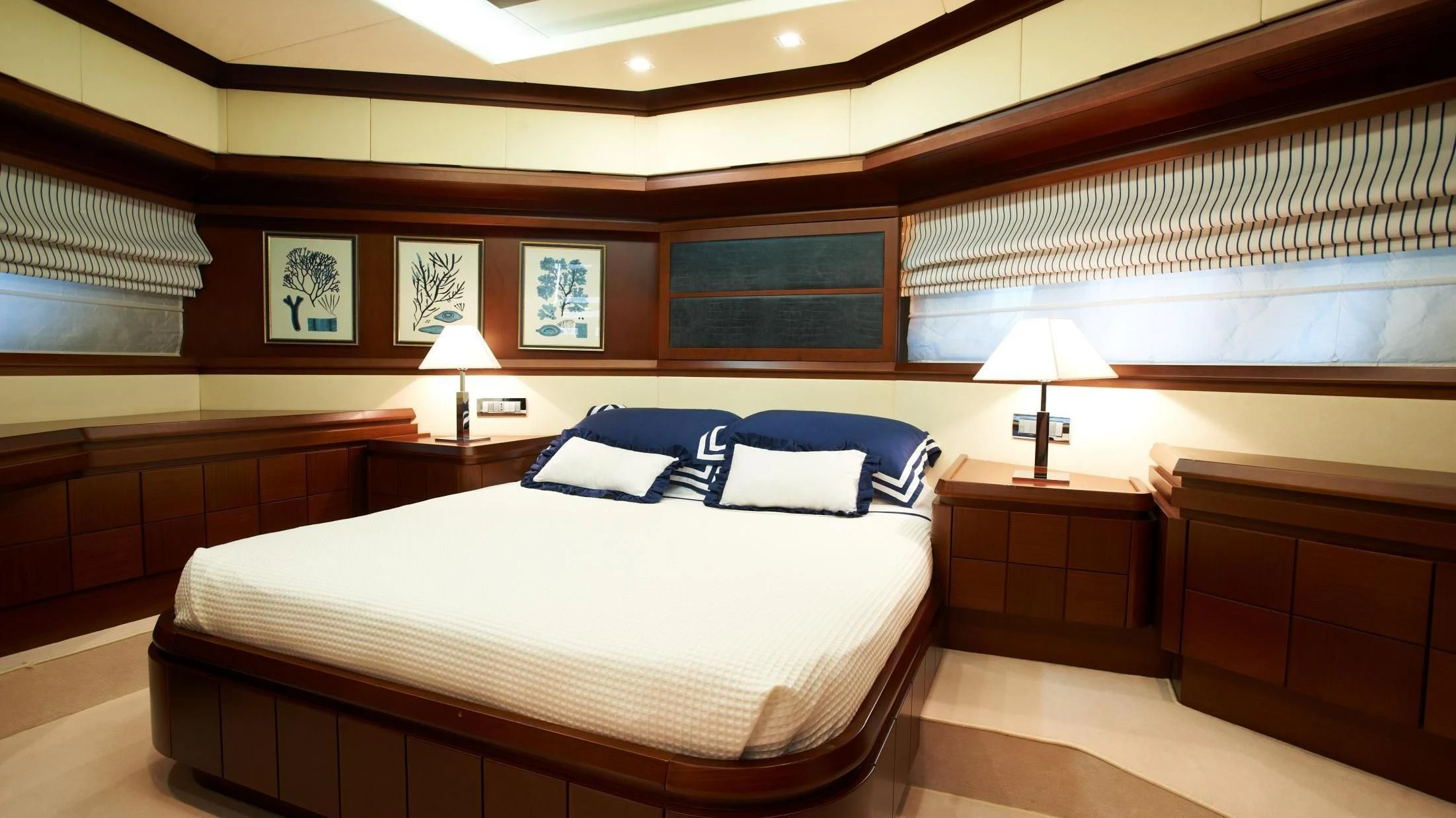 a room with a bed and a lamp aboard KOUKLES Yacht for Sale