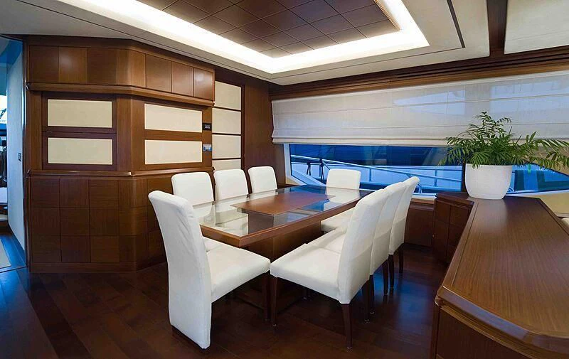 a room with a table chairs and a window aboard KOUKLES Yacht for Sale