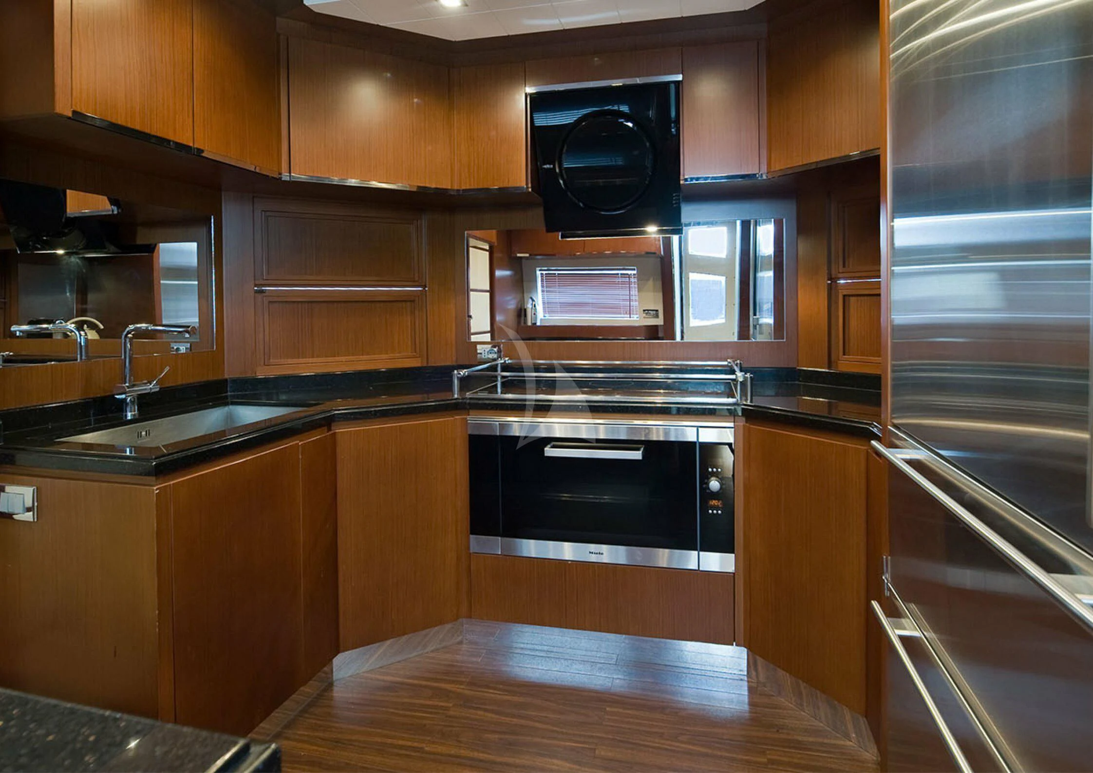 a kitchen with wooden cabinets aboard KOUKLES Yacht for Sale
