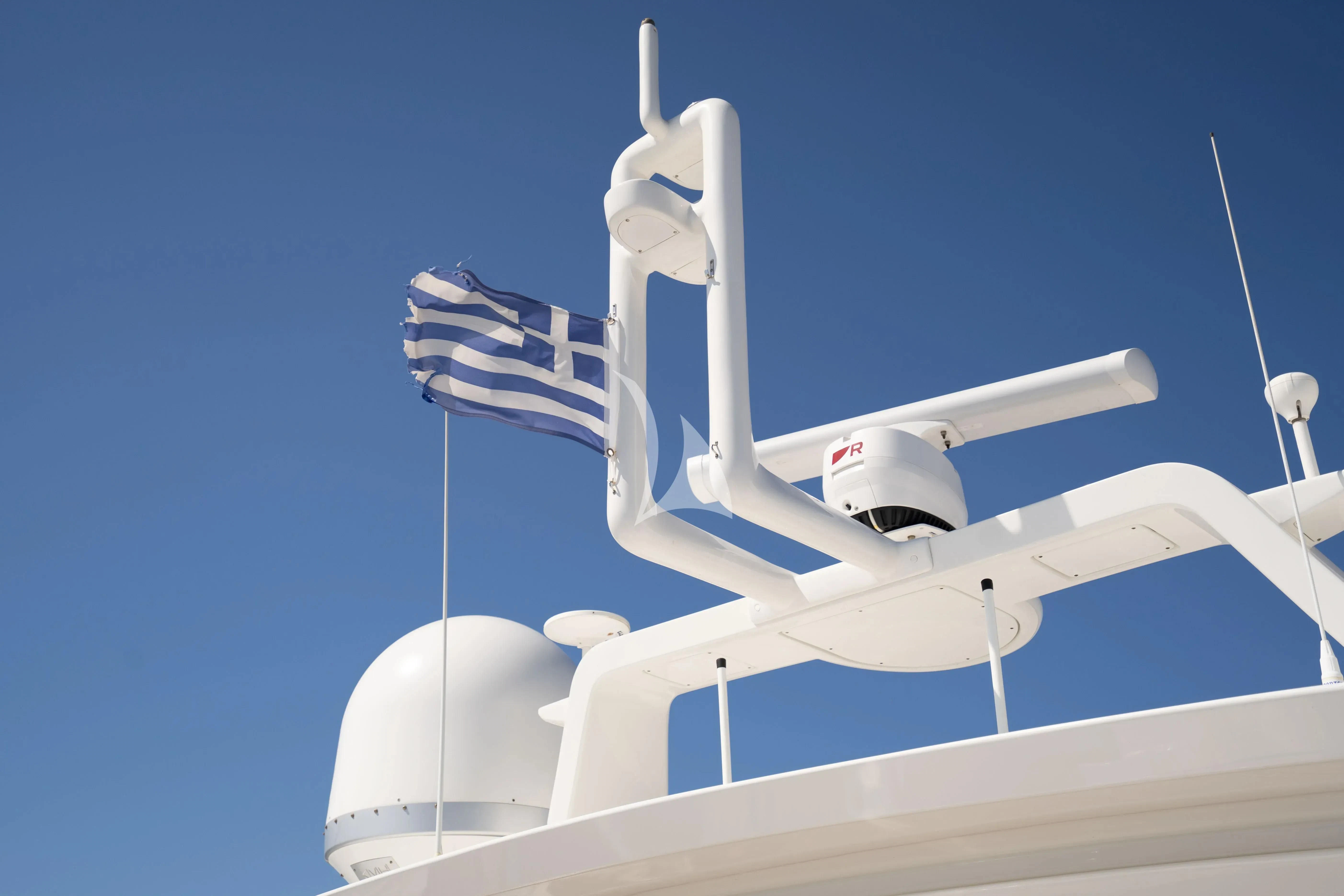 a white satellite dish with a flag on it aboard KOUKLES Yacht for Sale