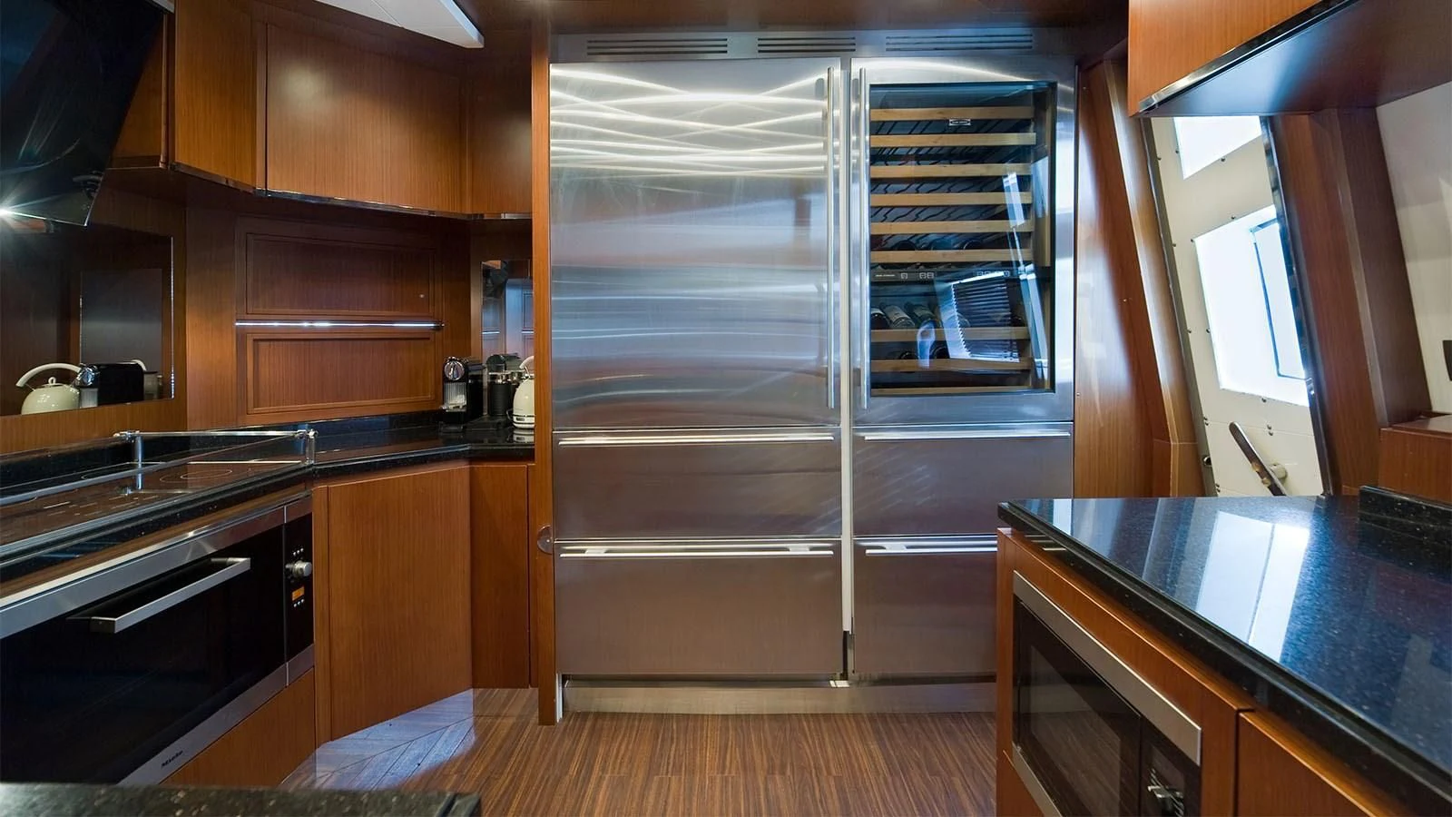 a kitchen with a refrigerator aboard KOUKLES Yacht for Sale