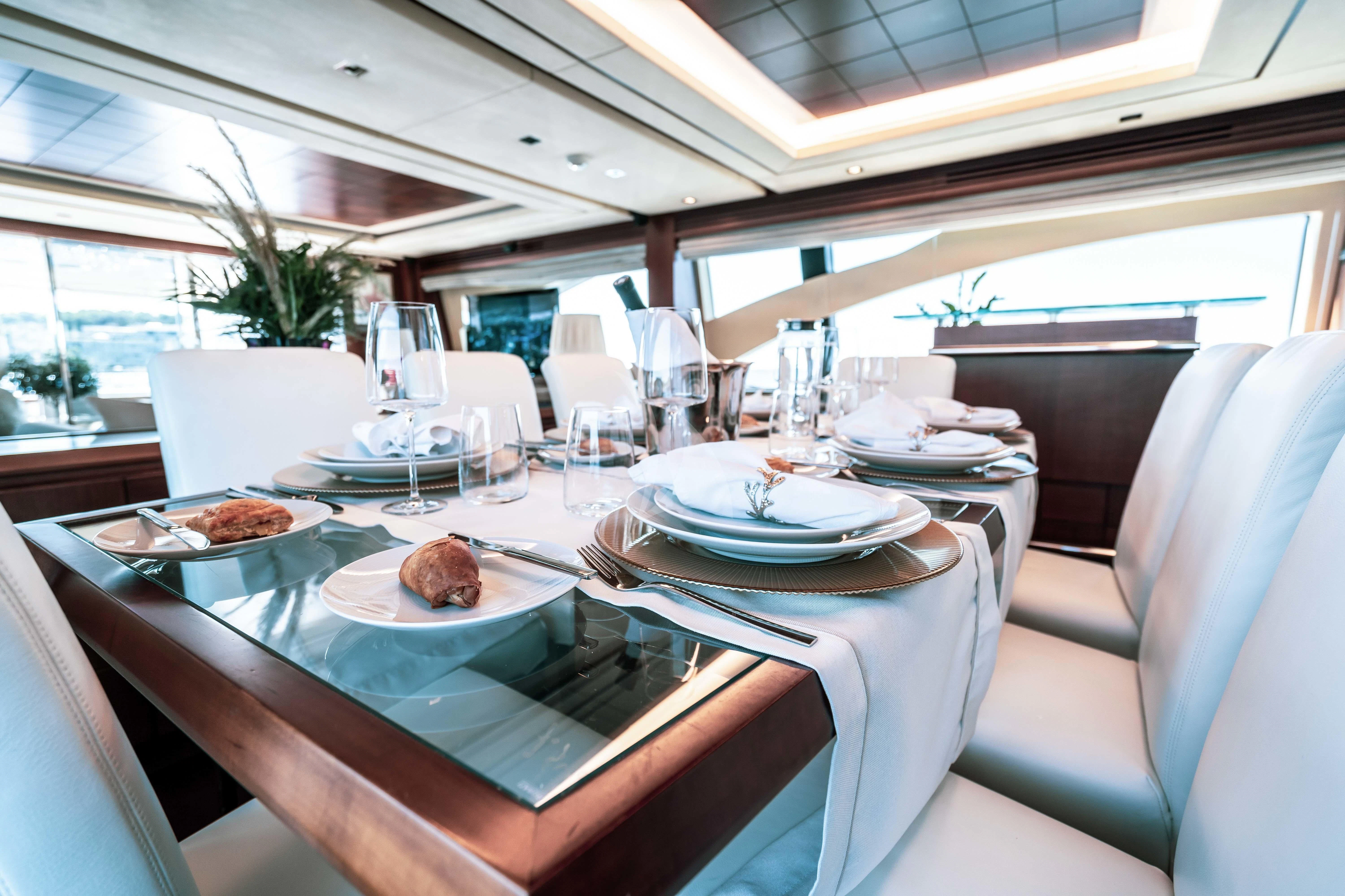 a table with plates and food on it aboard KOUKLES Yacht for Sale