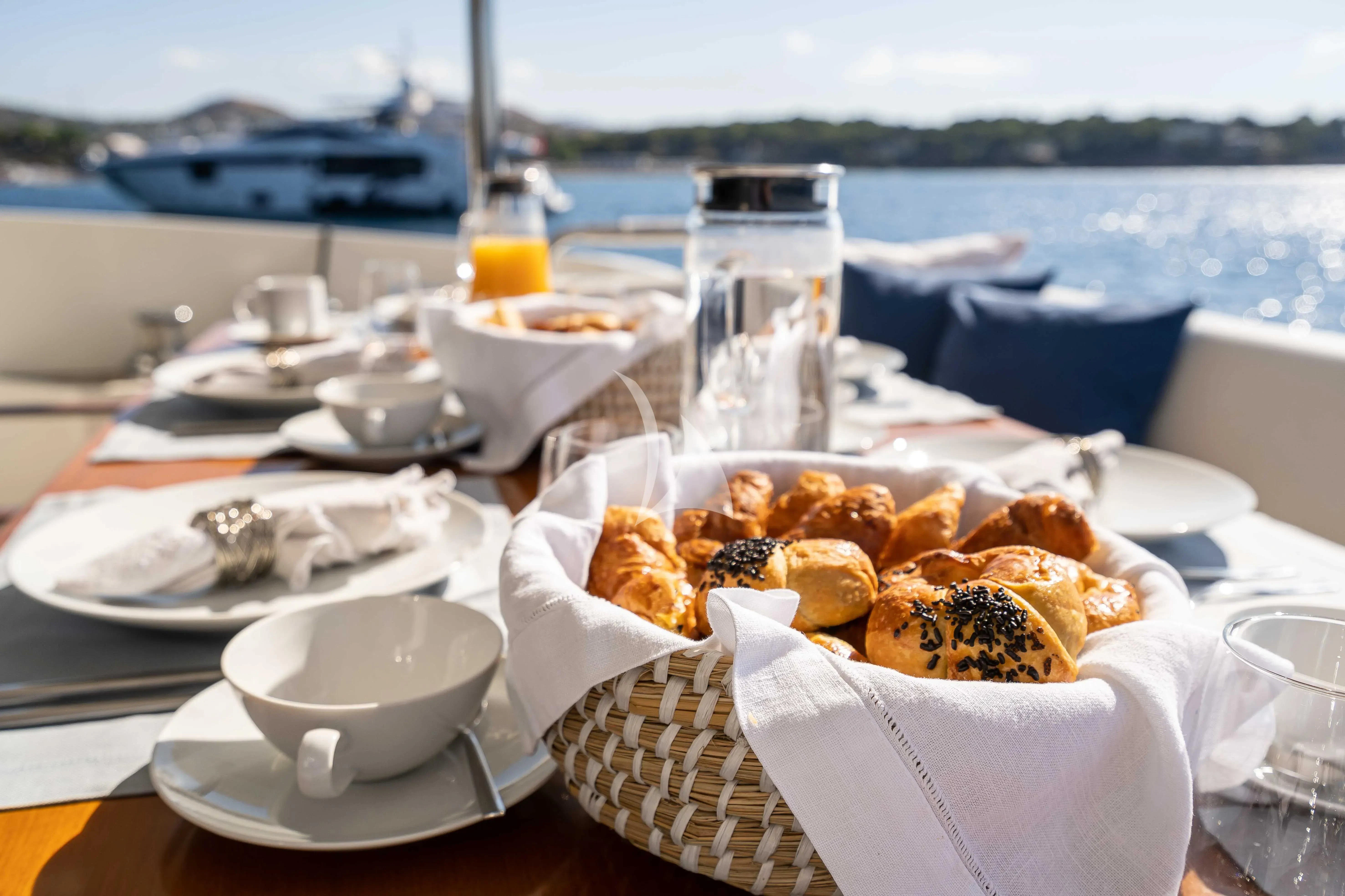 a table with food and drinks on it aboard KOUKLES Yacht for Sale