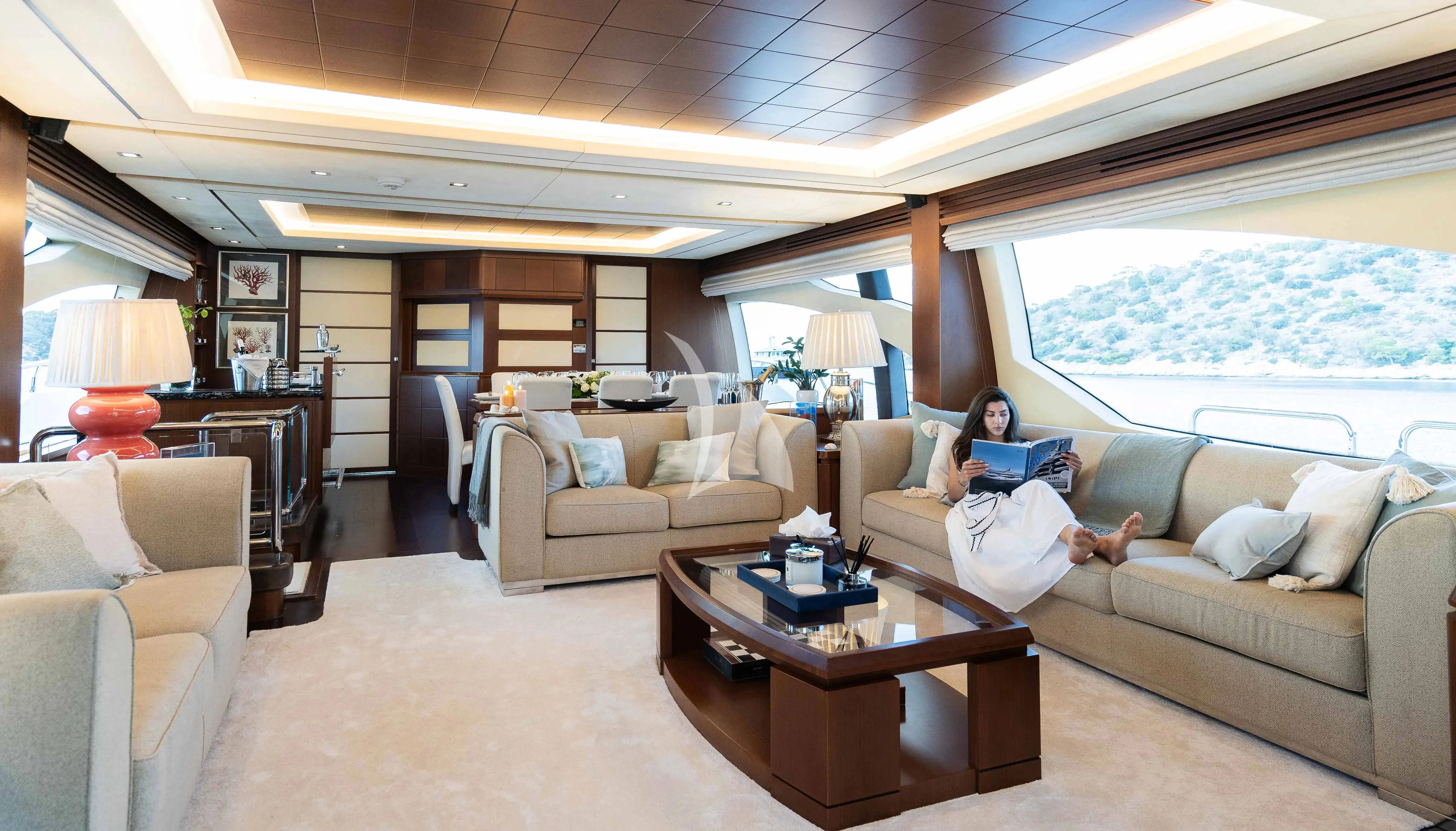 a person sitting on a couch in a living room aboard KOUKLES Yacht for Sale
