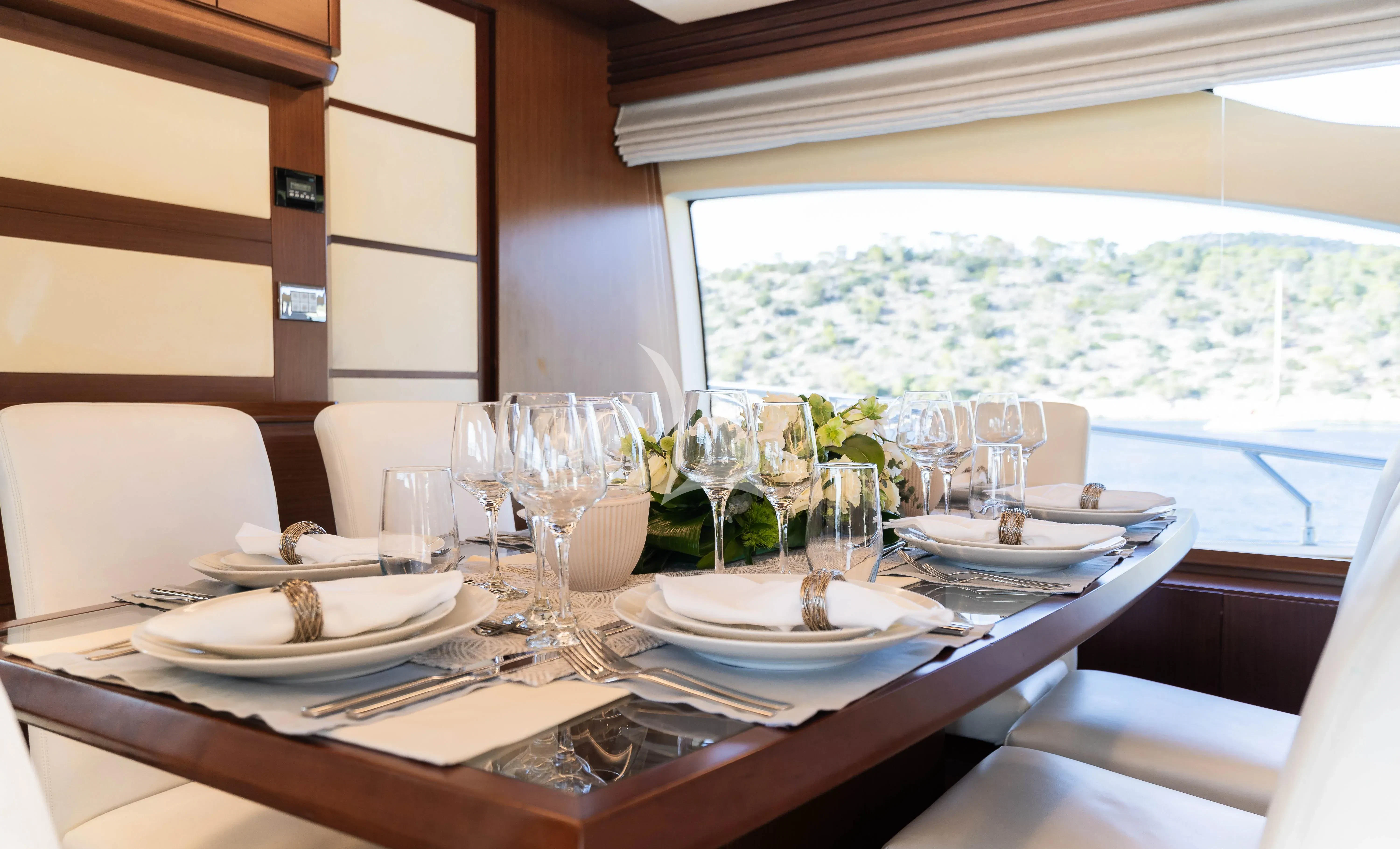 a table set with plates and glasses aboard KOUKLES Yacht for Sale