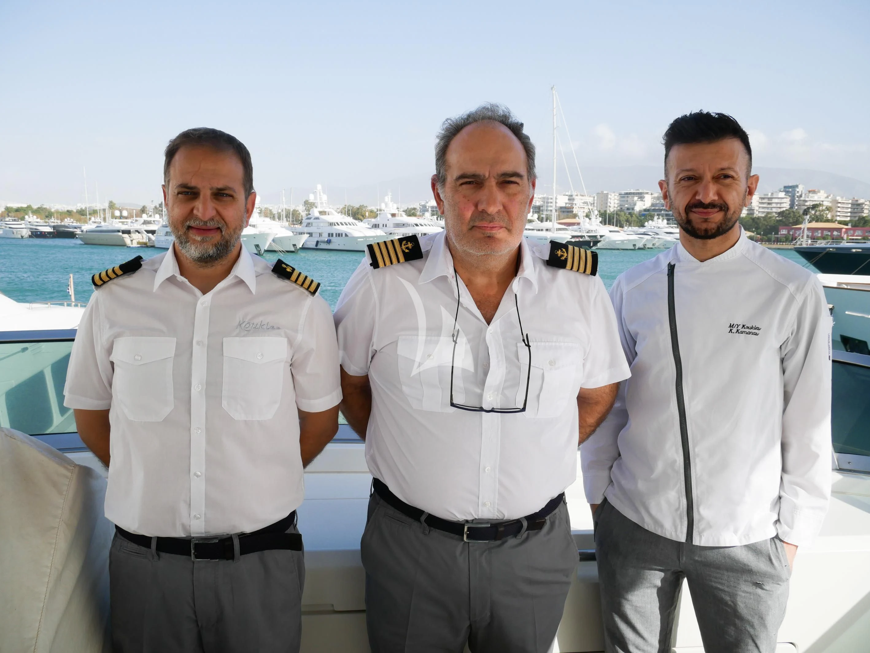 a group of men posing for a photo aboard KOUKLES Yacht for Sale