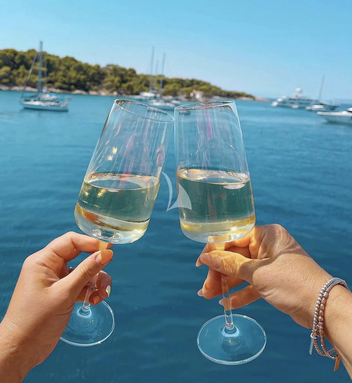 a pair of glasses with champagne aboard KOUKLES Yacht for Sale