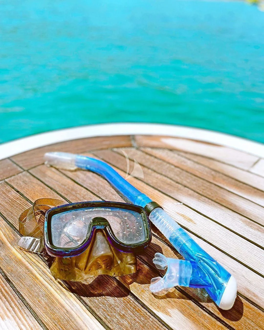 sunglasses on a table aboard KOUKLES Yacht for Sale