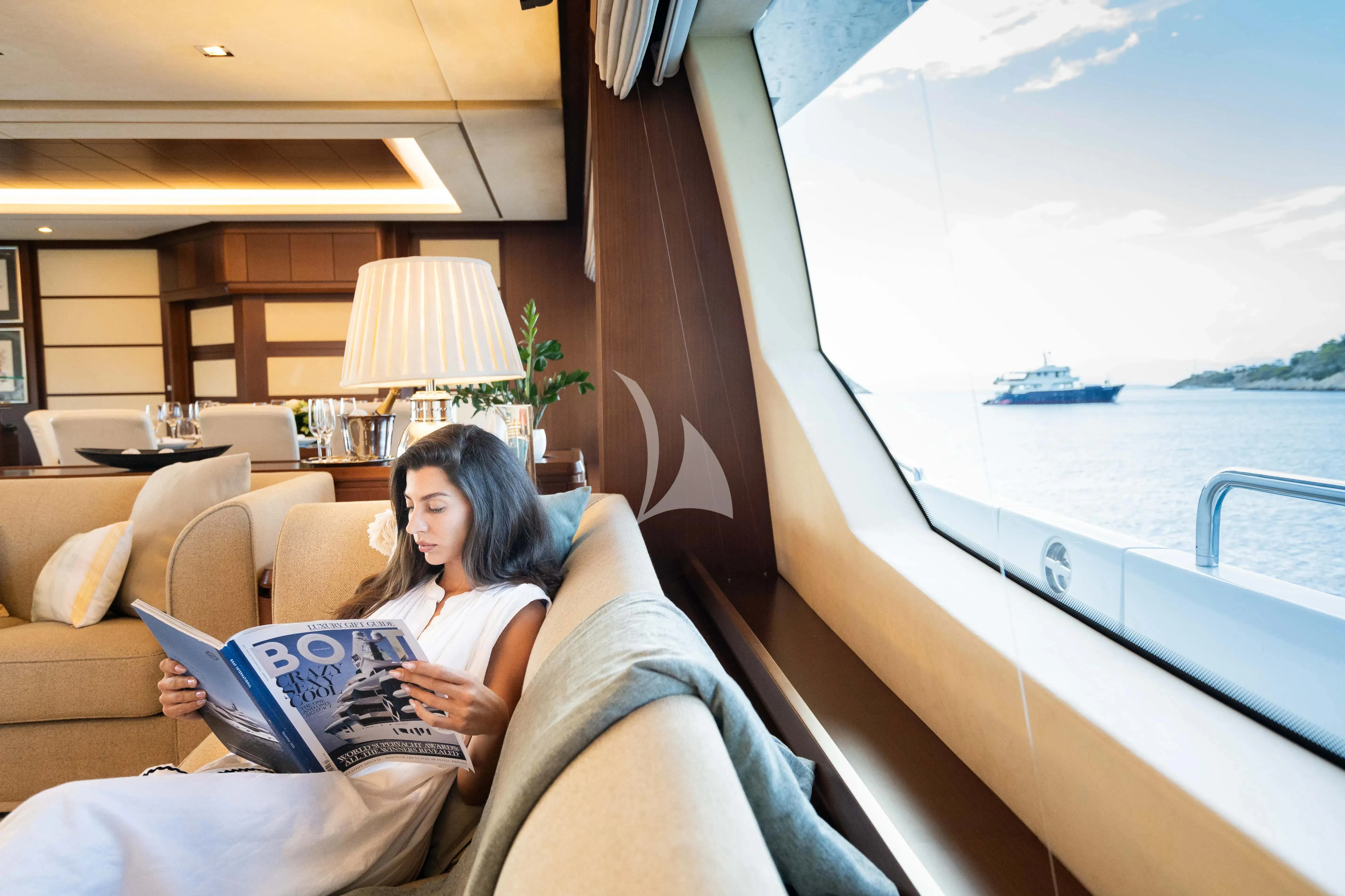 a person sitting on a couch with a laptop aboard KOUKLES Yacht for Sale