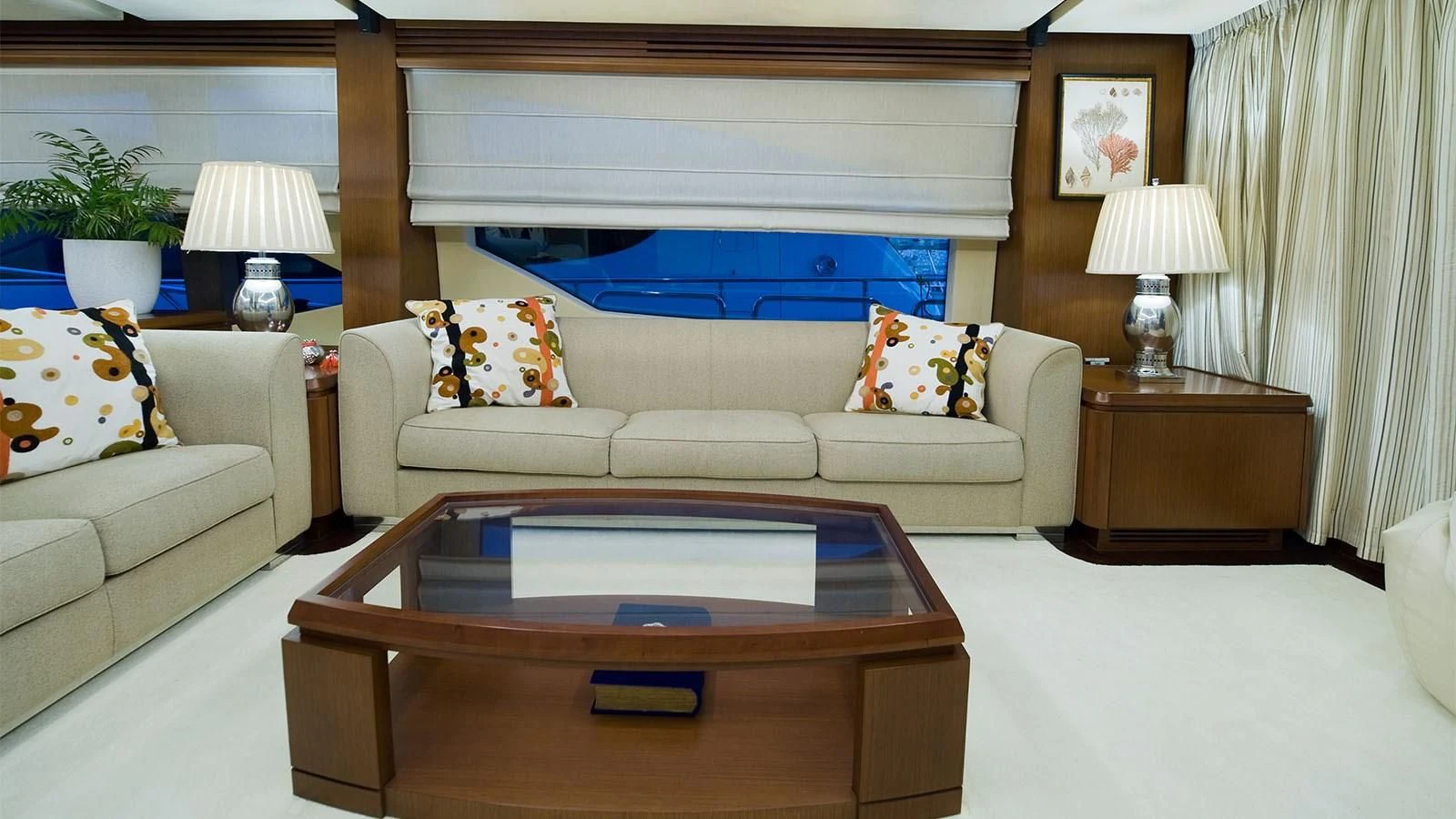 a living room with a white couch and a coffee table aboard KOUKLES Yacht for Sale