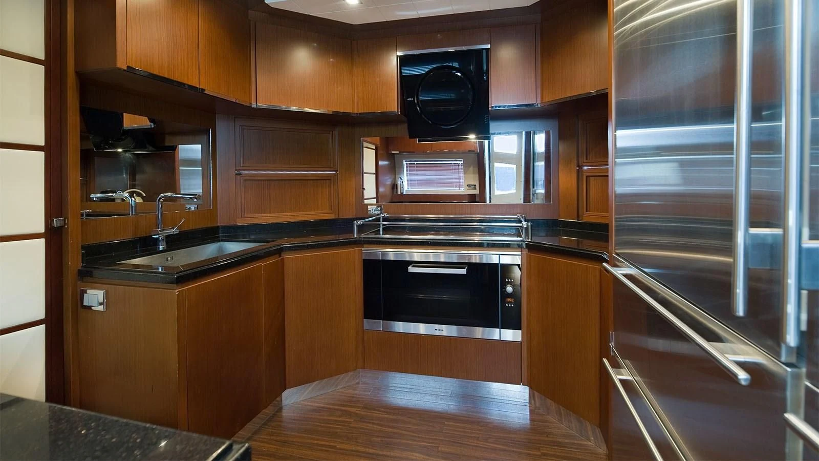 a kitchen with wooden cabinets aboard KOUKLES Yacht for Sale