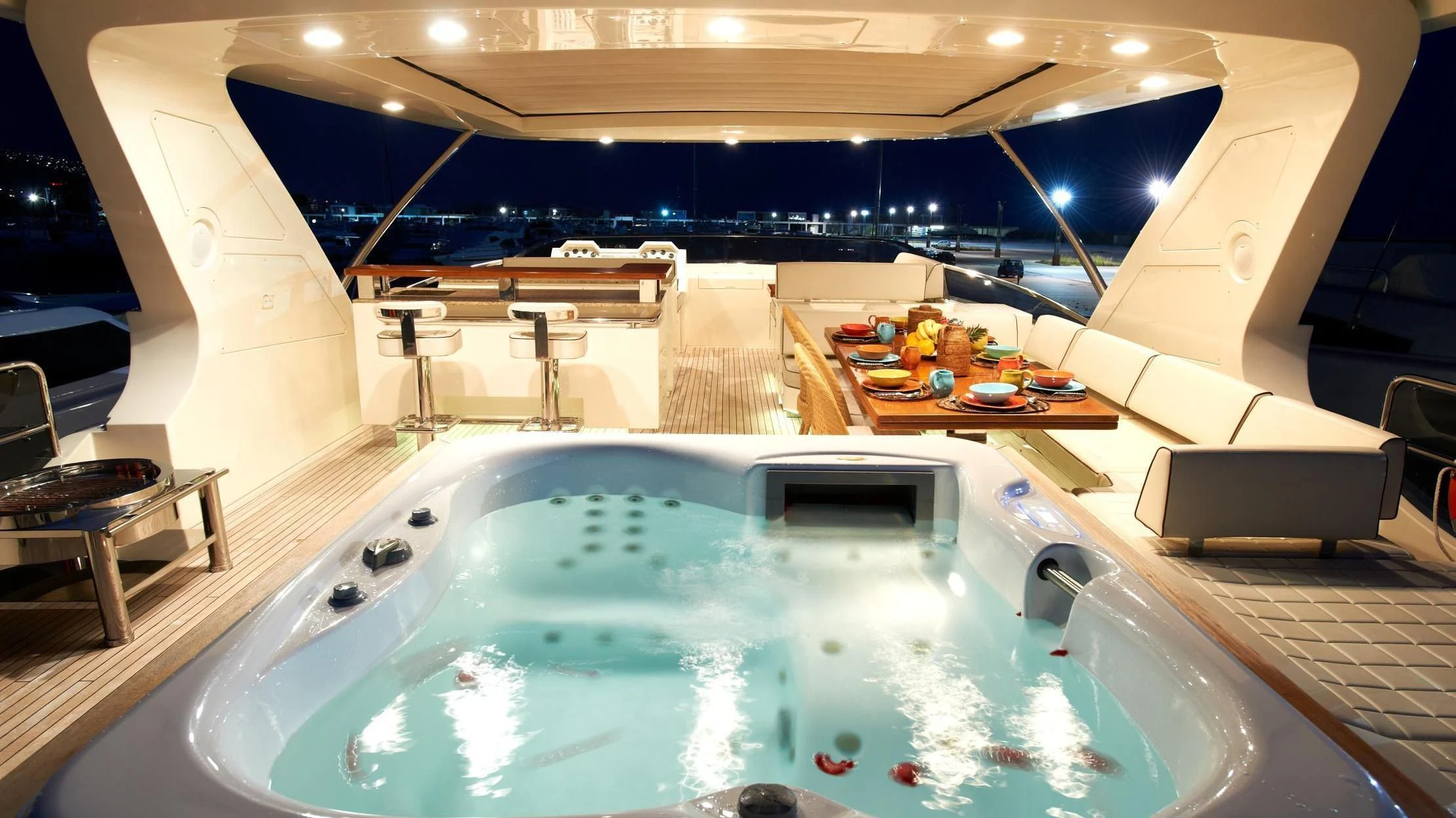 a pool with a table and chairs aboard KOUKLES Yacht for Sale