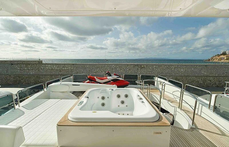 a white yacht on a deck aboard KOUKLES Yacht for Sale