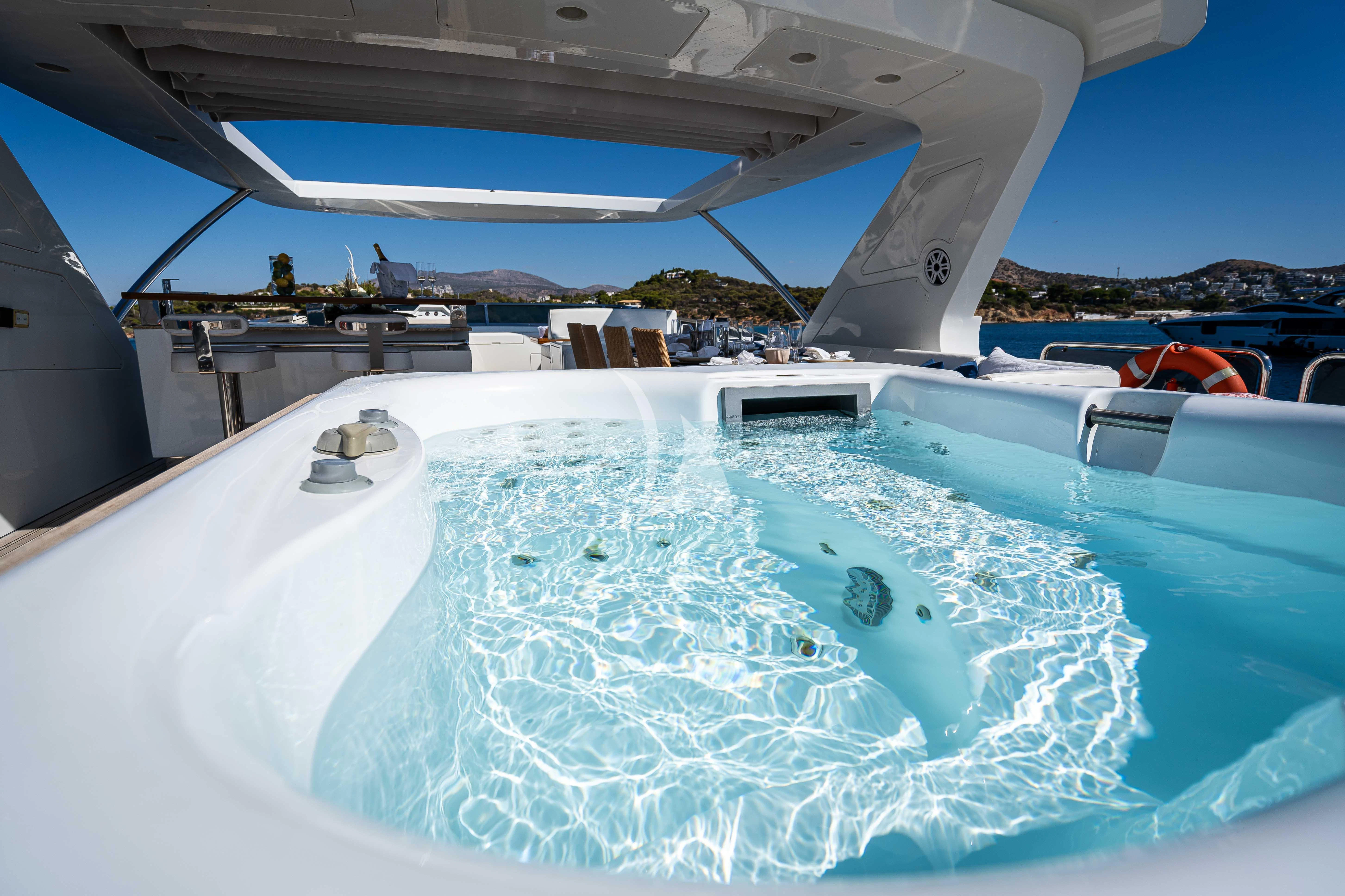 a pool with a boat in the background aboard KOUKLES Yacht for Sale