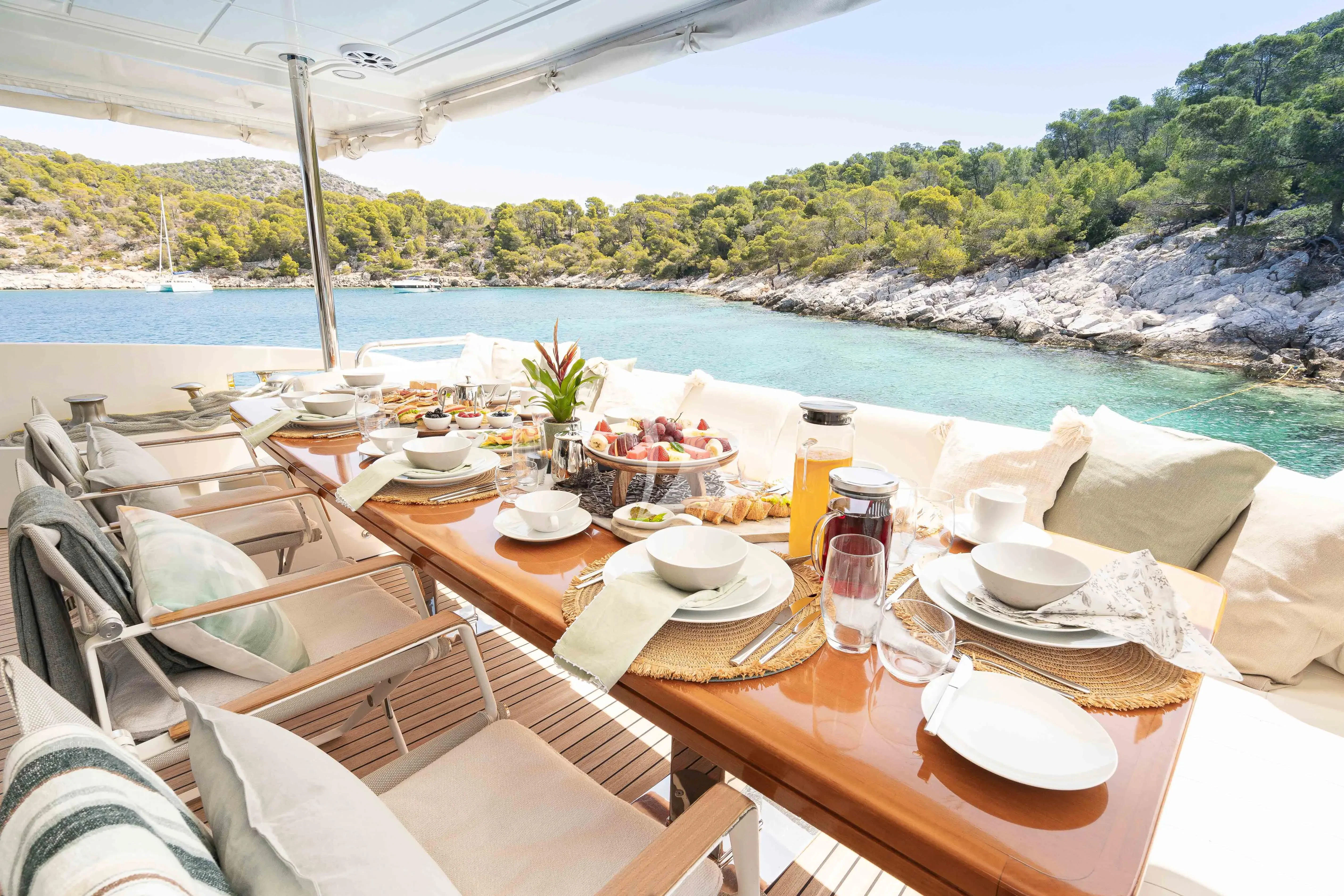 a table set for a meal on a boat aboard KOUKLES Yacht for Sale