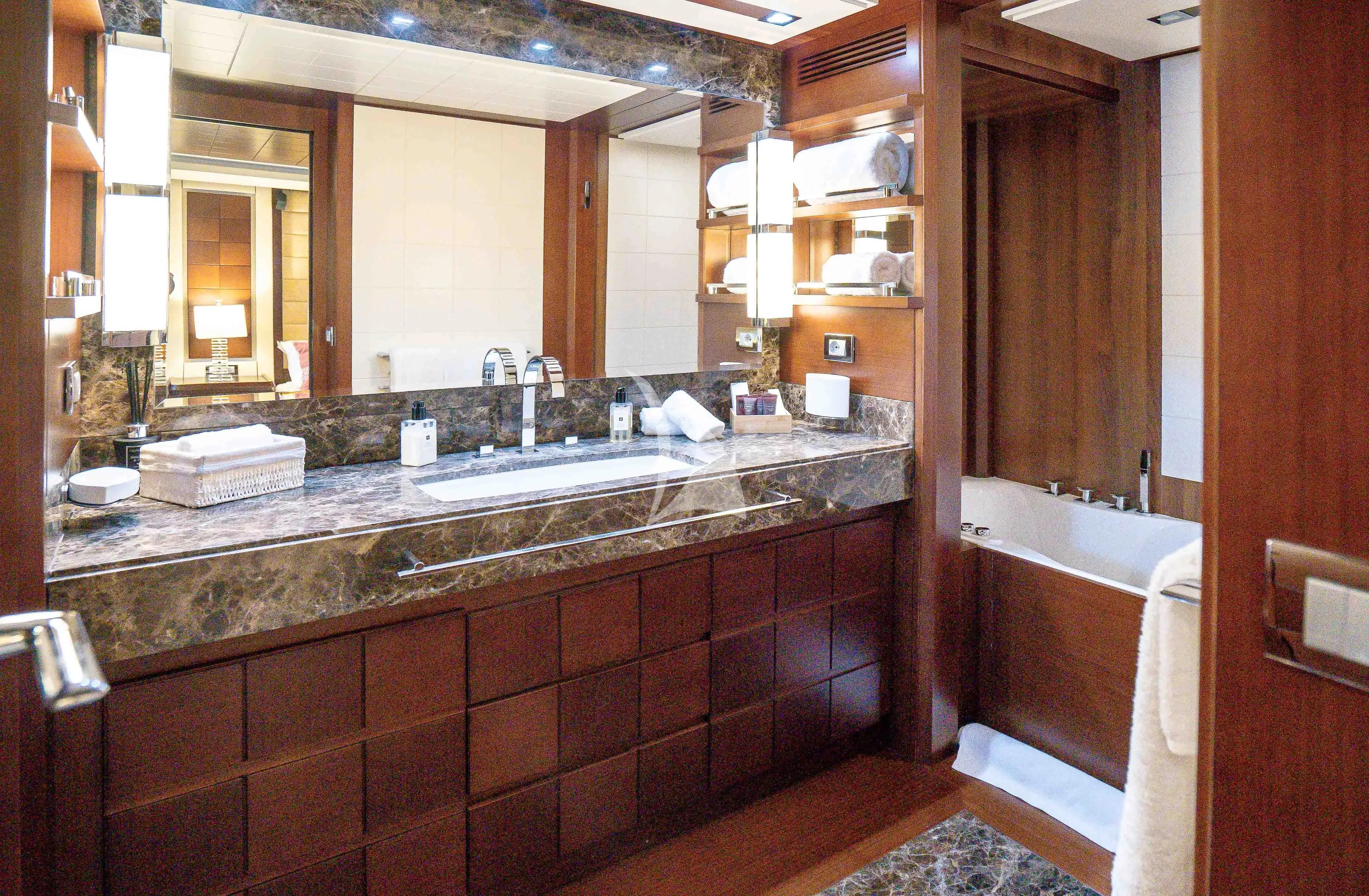 a bathroom with a sink and bathtub aboard KOUKLES Yacht for Sale