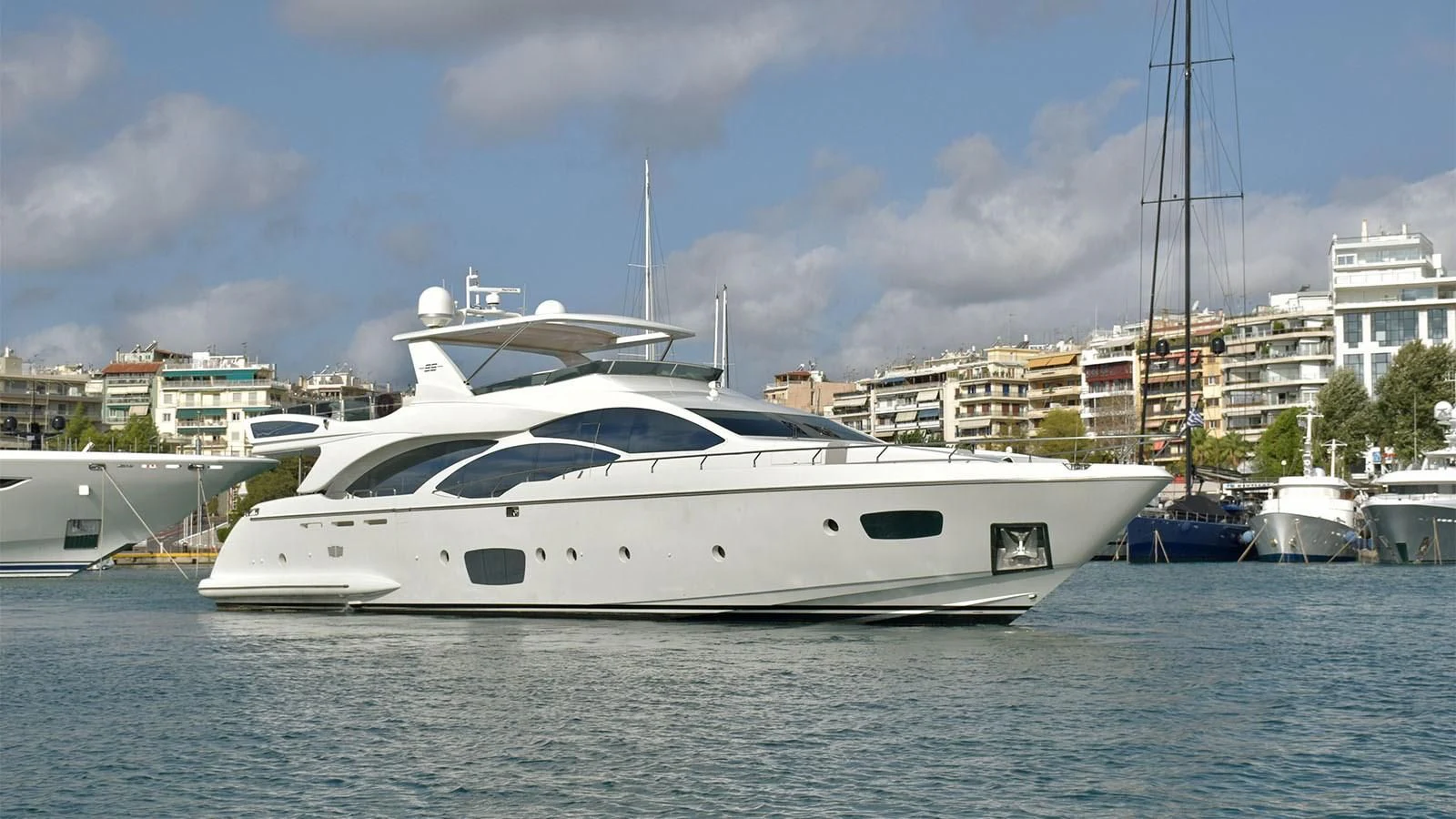 a white yacht in a harbor aboard KOUKLES Yacht for Sale