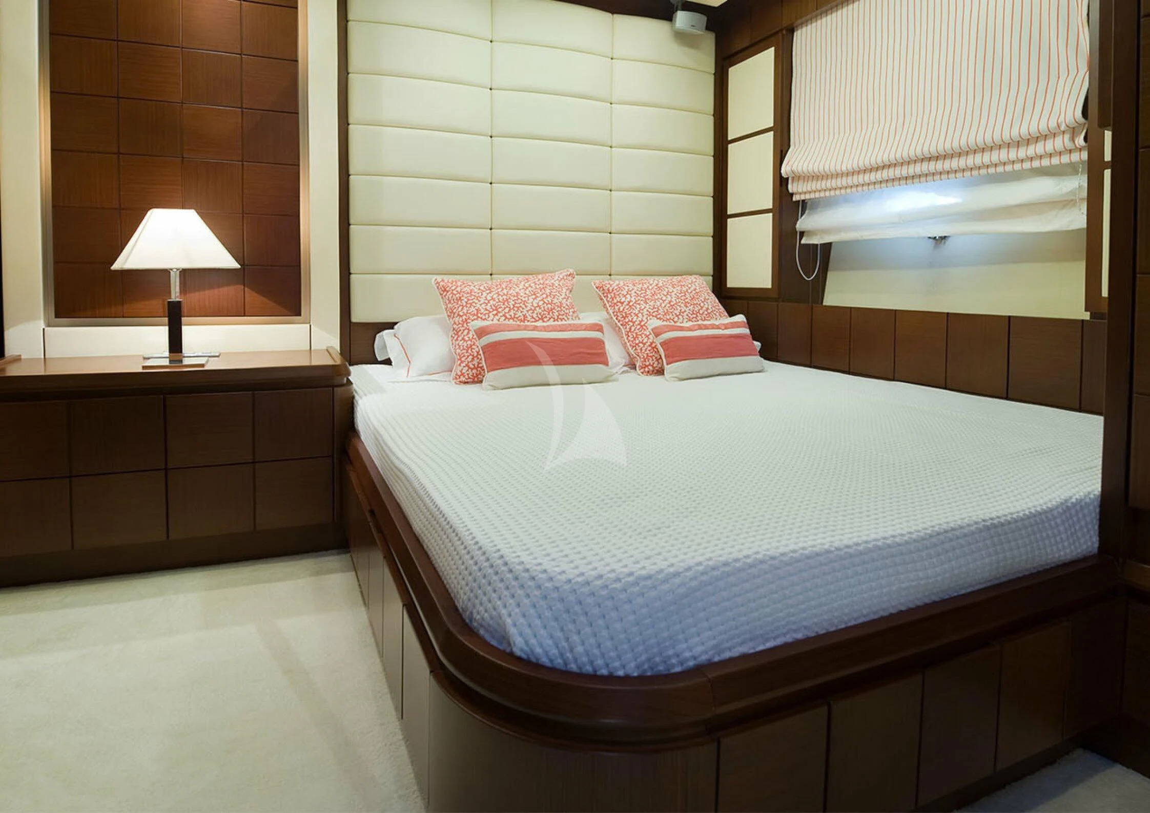 a bed with a white sheet and red pillows aboard KOUKLES Yacht for Sale