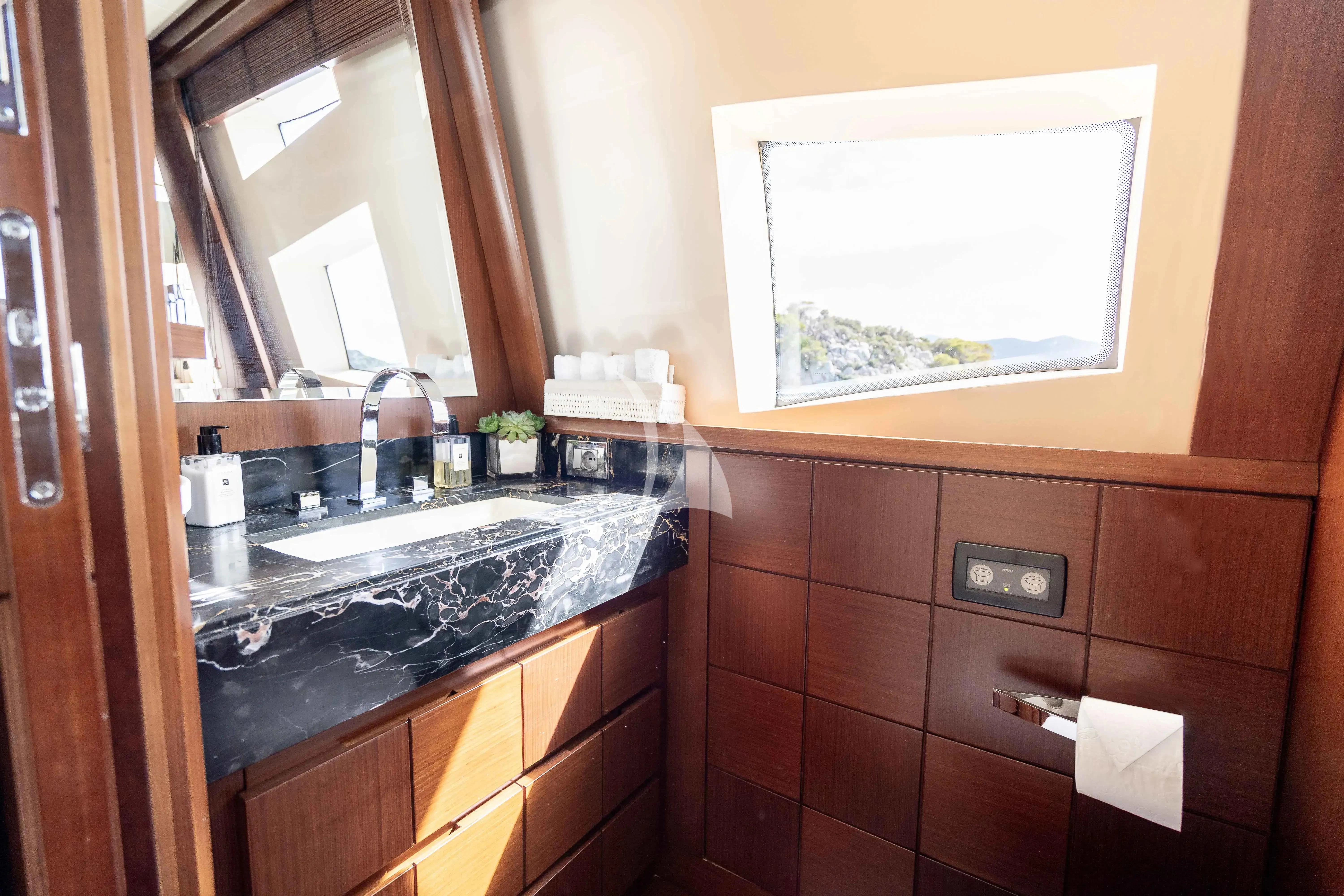 a bathroom with a sink and a mirror aboard KOUKLES Yacht for Sale