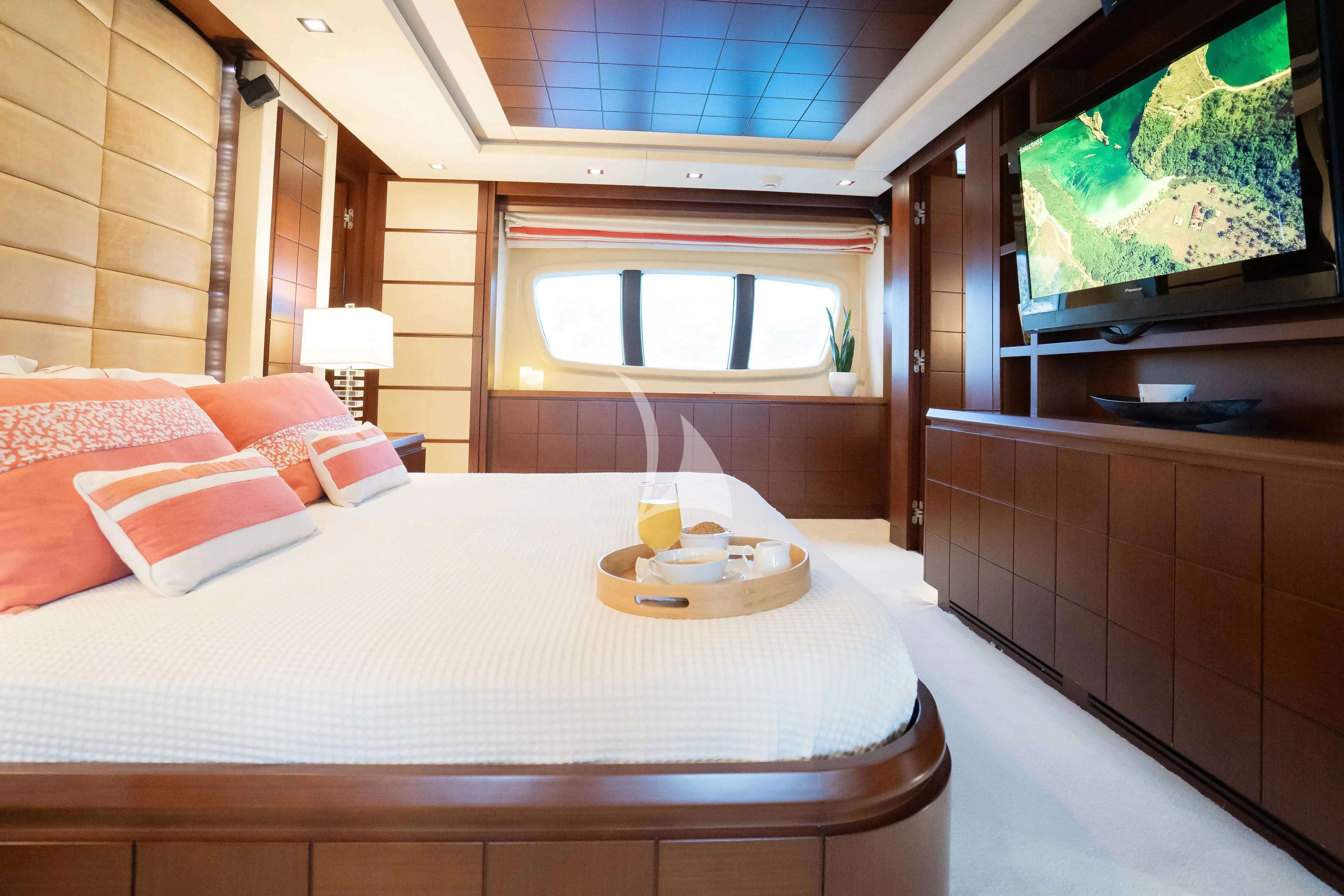 a bed with a white bed spread aboard KOUKLES Yacht for Sale