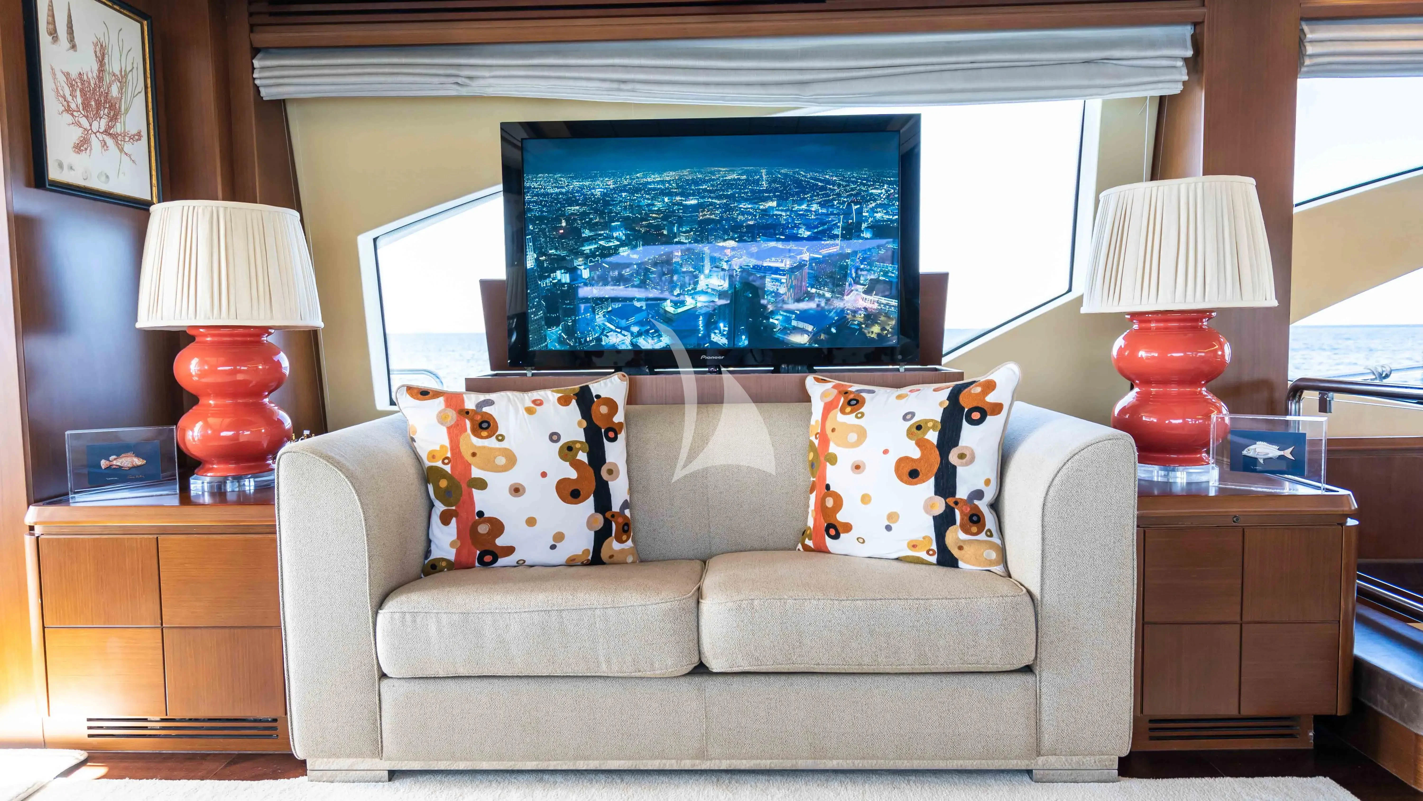 a living room with a large television aboard KOUKLES Yacht for Sale