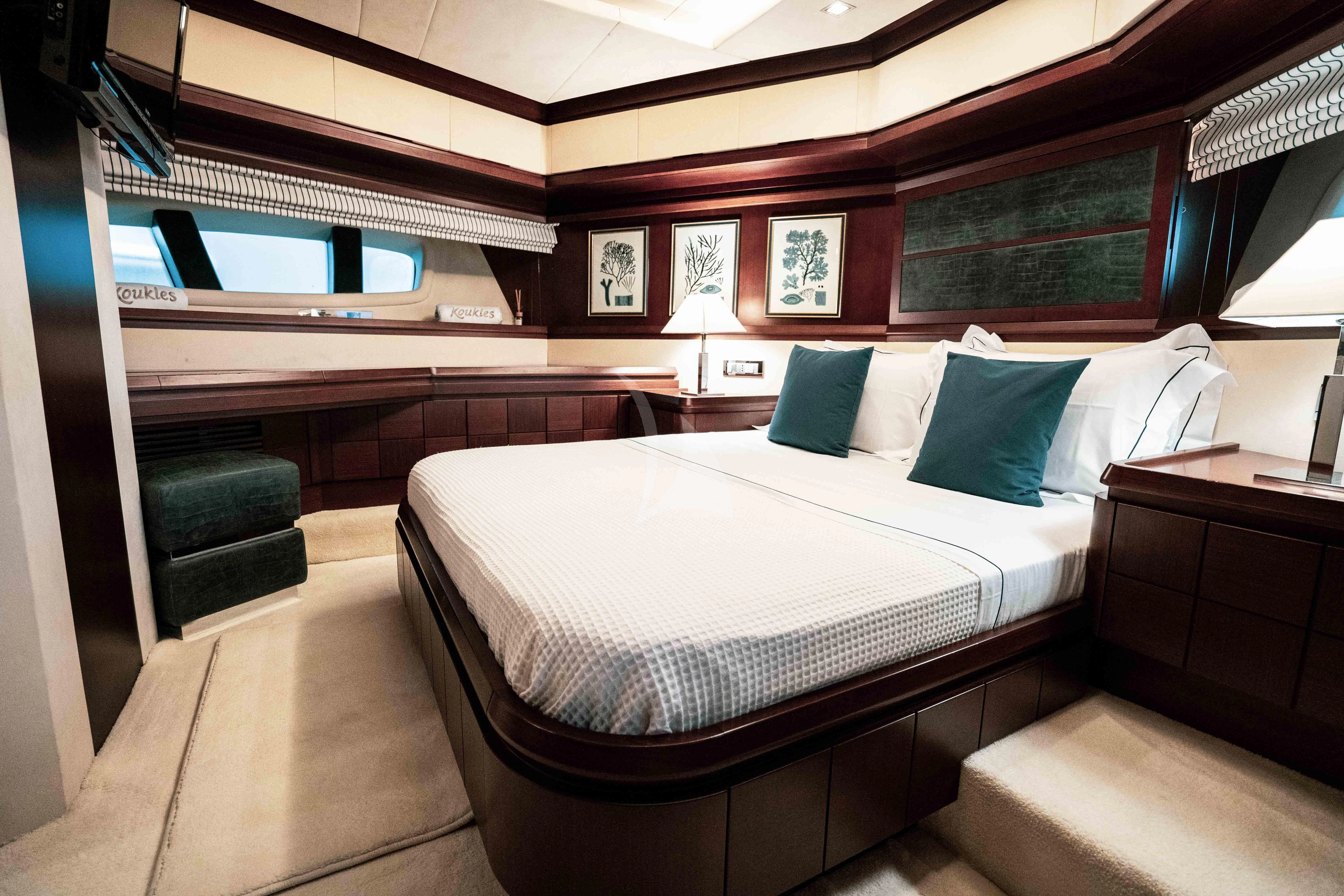 a room with a bed and a chair aboard KOUKLES Yacht for Sale
