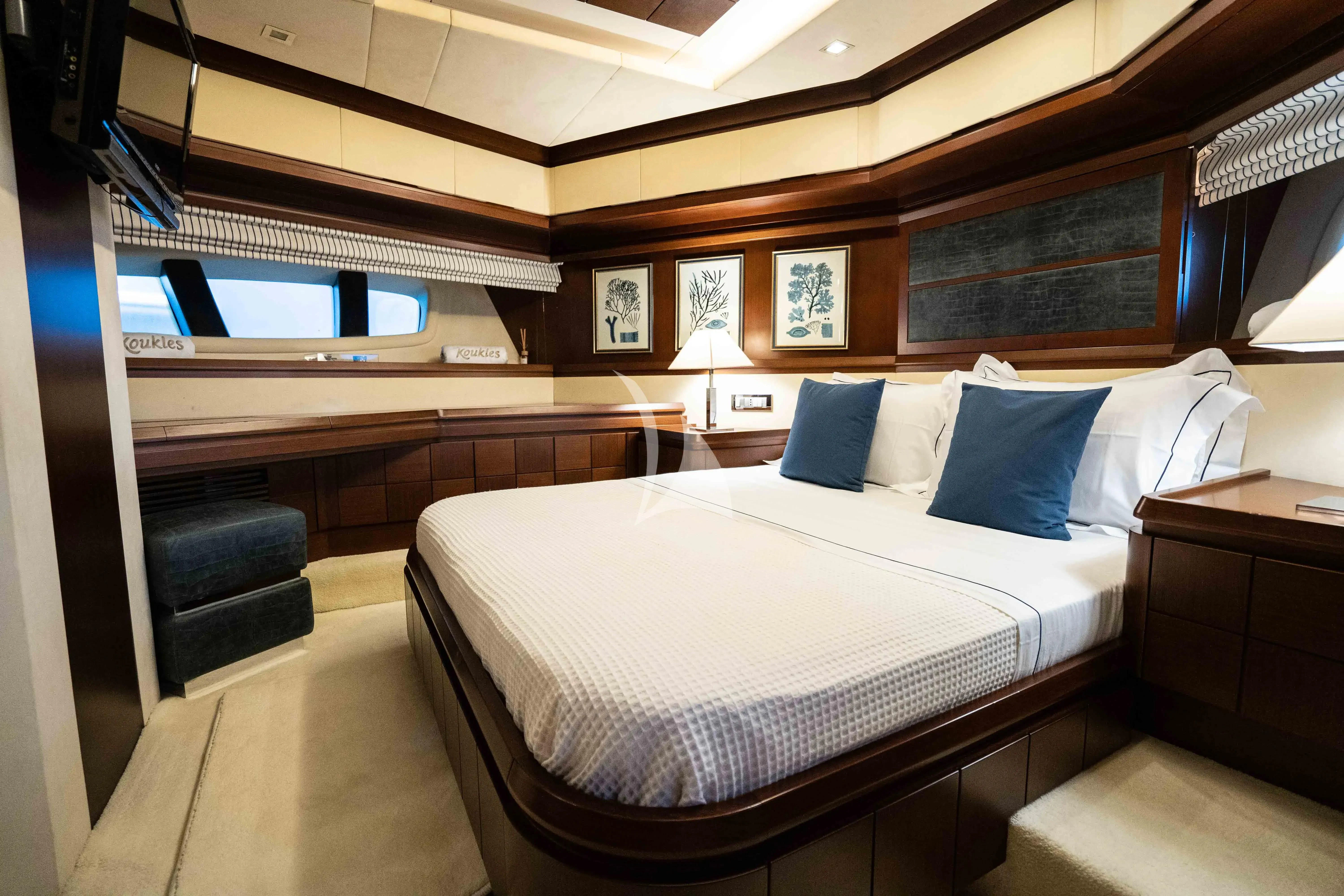 a room with a bed and a desk aboard KOUKLES Yacht for Sale