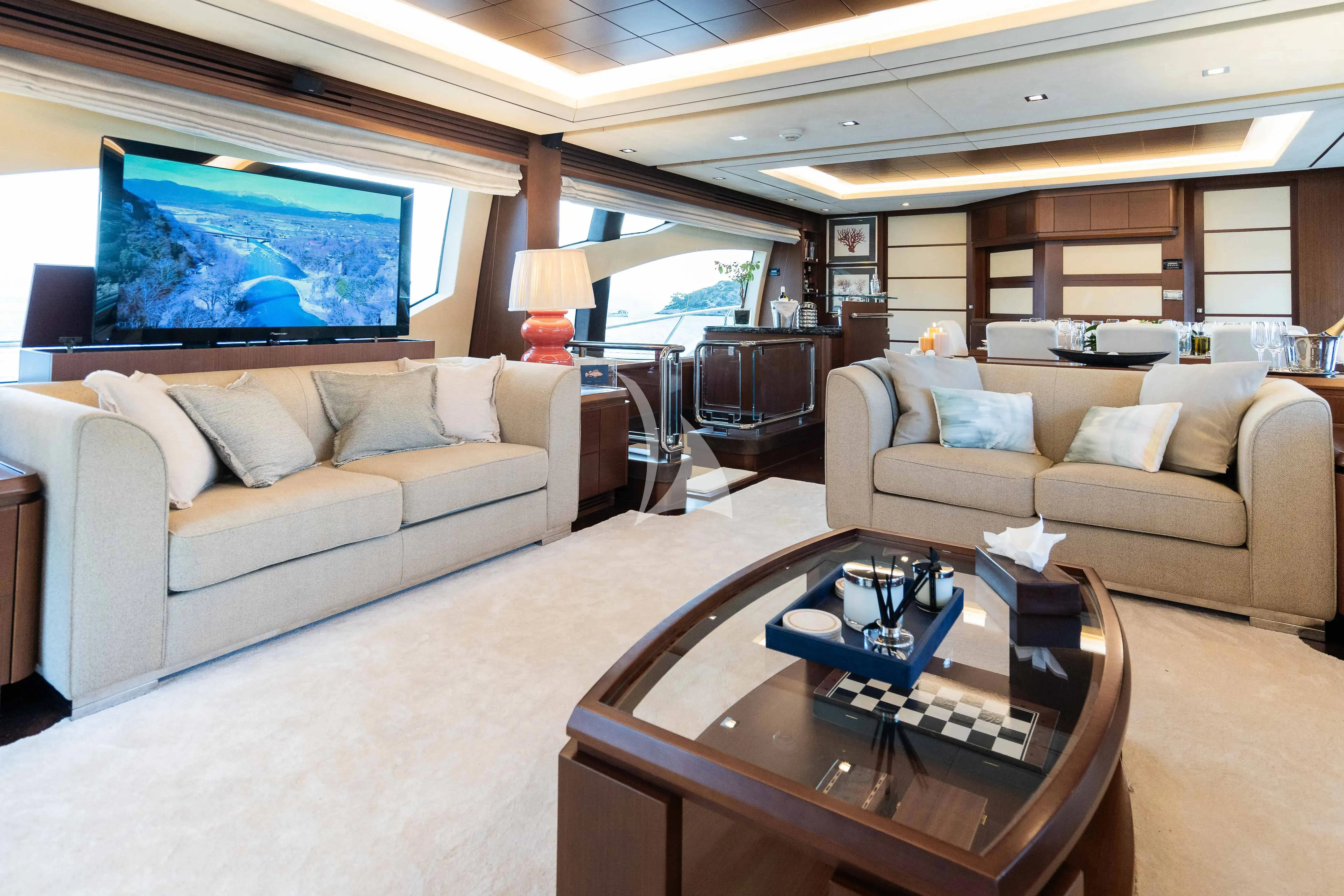 a living room with a large screen aboard KOUKLES Yacht for Sale