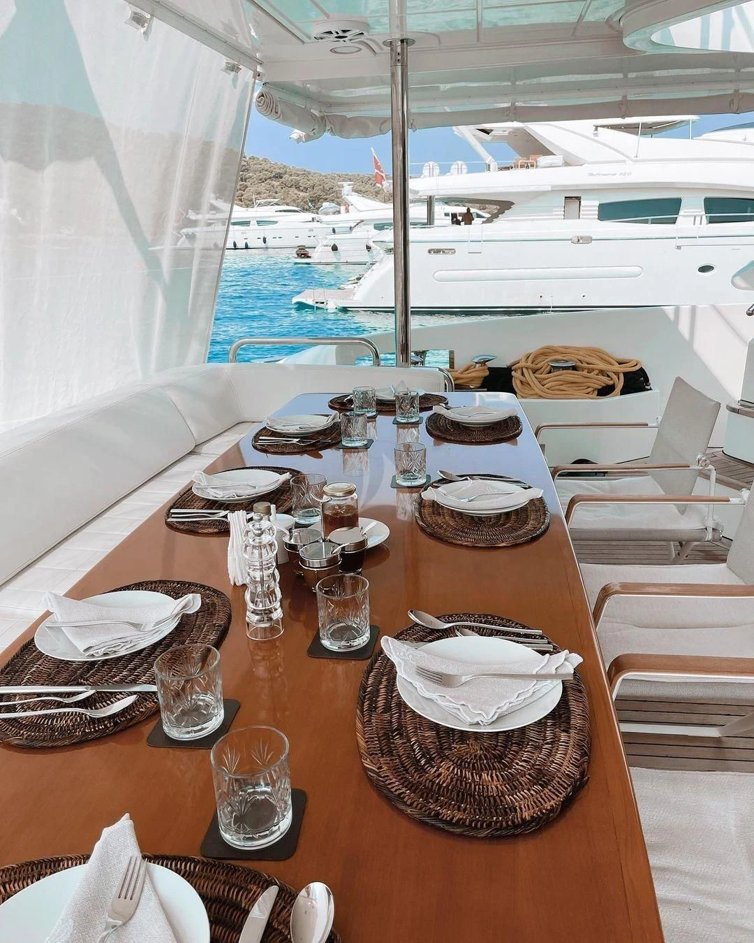 a table with plates and glasses on it aboard KOUKLES Yacht for Sale