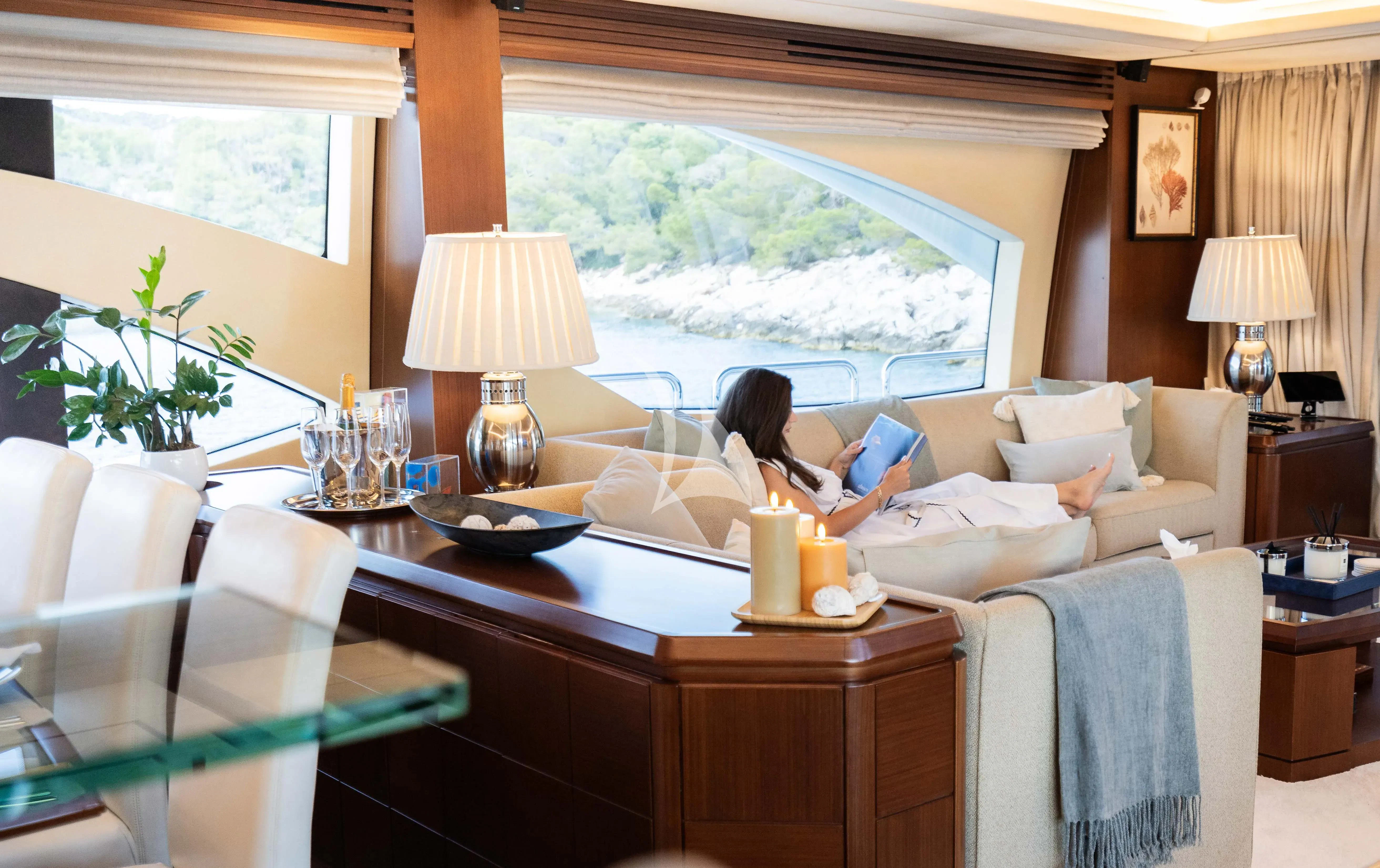 a person sitting on a couch in a living room aboard KOUKLES Yacht for Sale