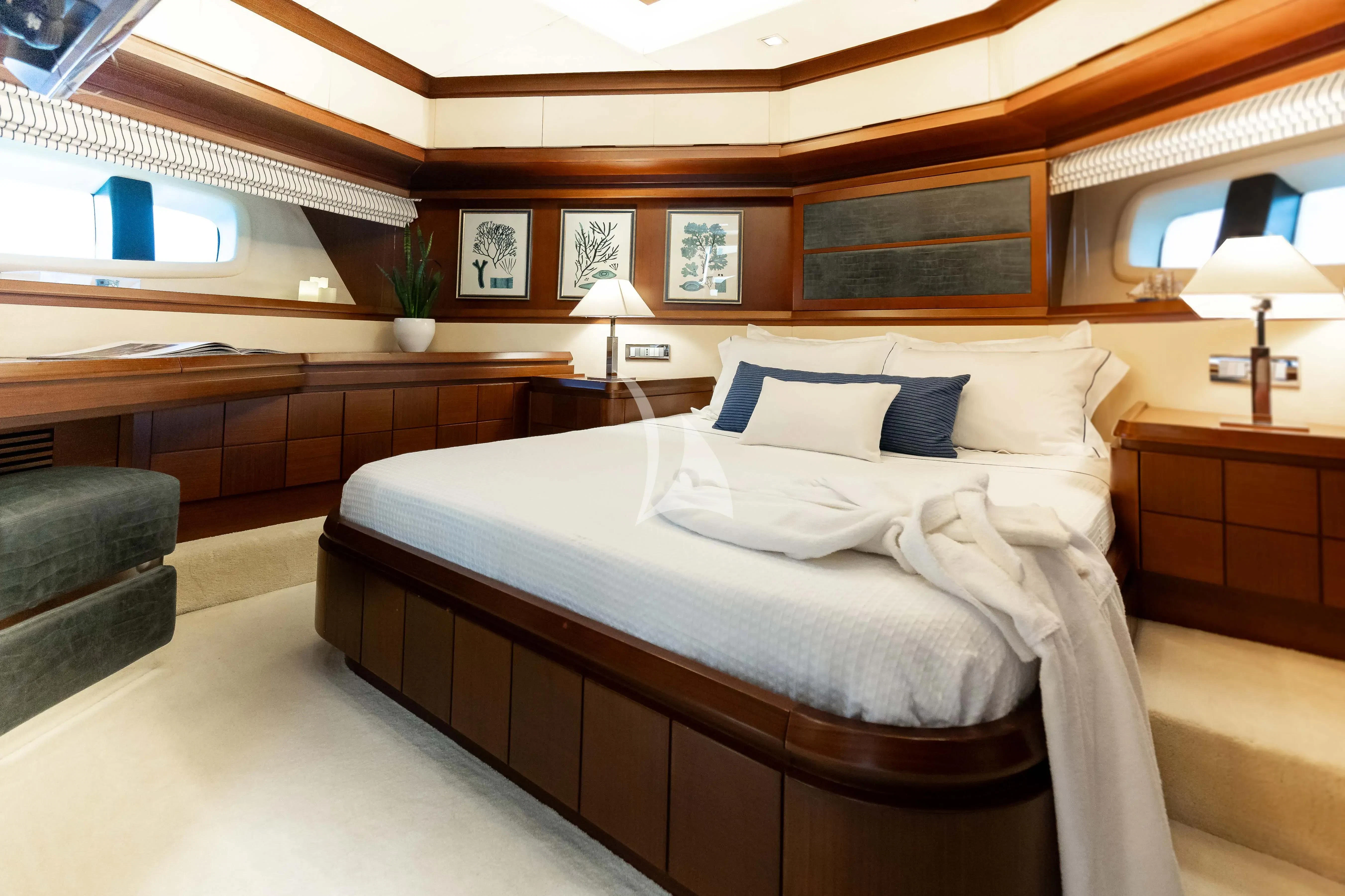 a bed with a couch and a chair in a room with a window aboard KOUKLES Yacht for Sale
