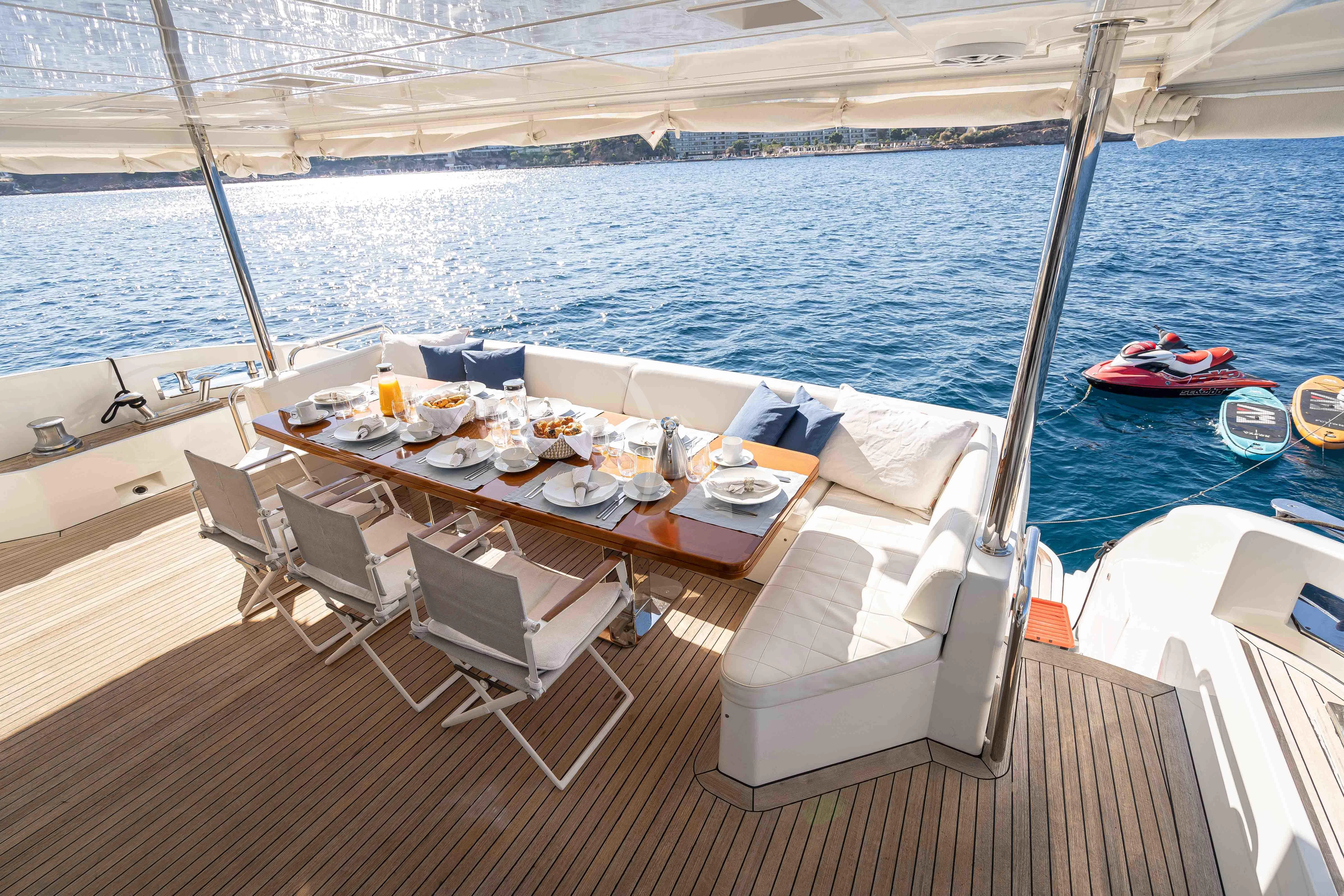 a table set for a meal on a boat aboard KOUKLES Yacht for Sale
