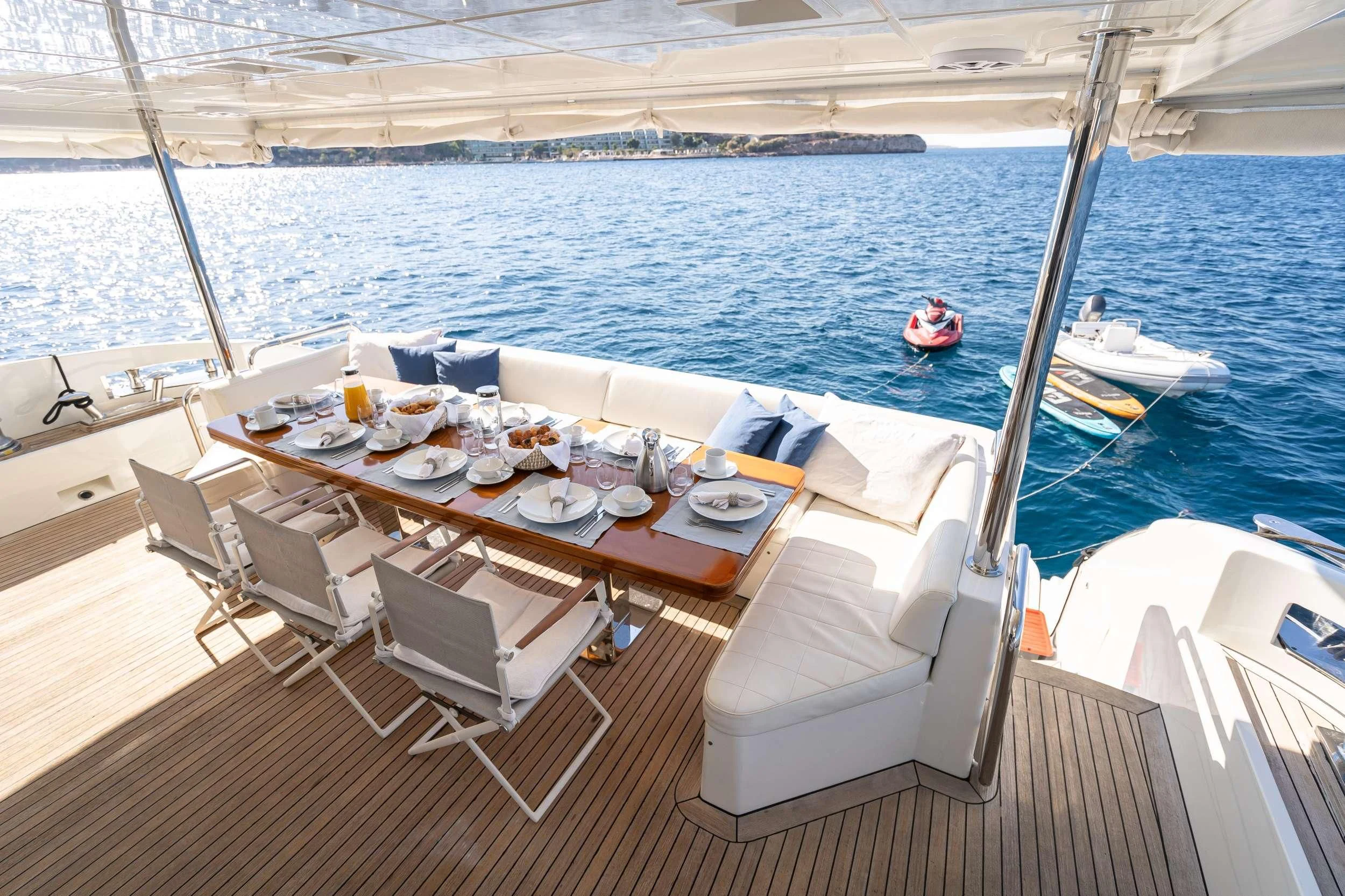a table set for a meal on a boat aboard KOUKLES Yacht for Sale