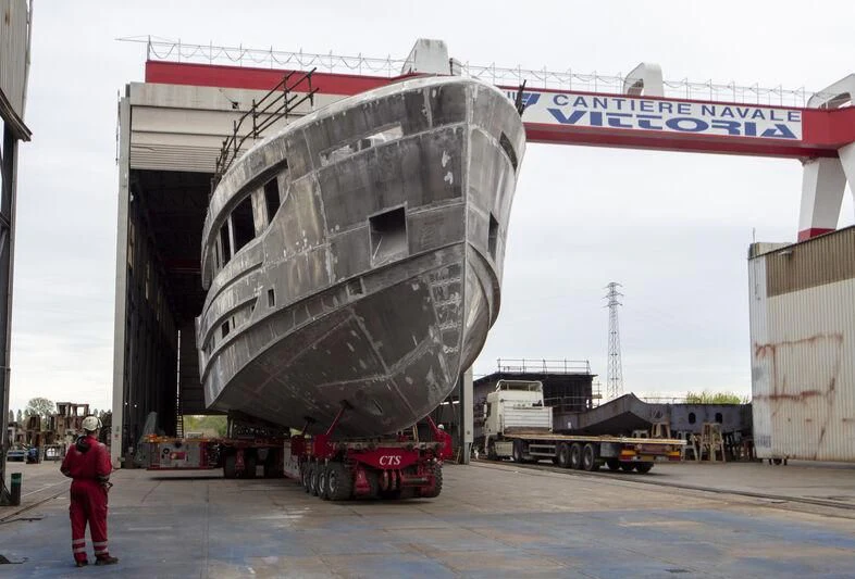 a person standing next to a large ship aboard VITTORIA VELOCE 32 RPH #01 Yacht for Sale